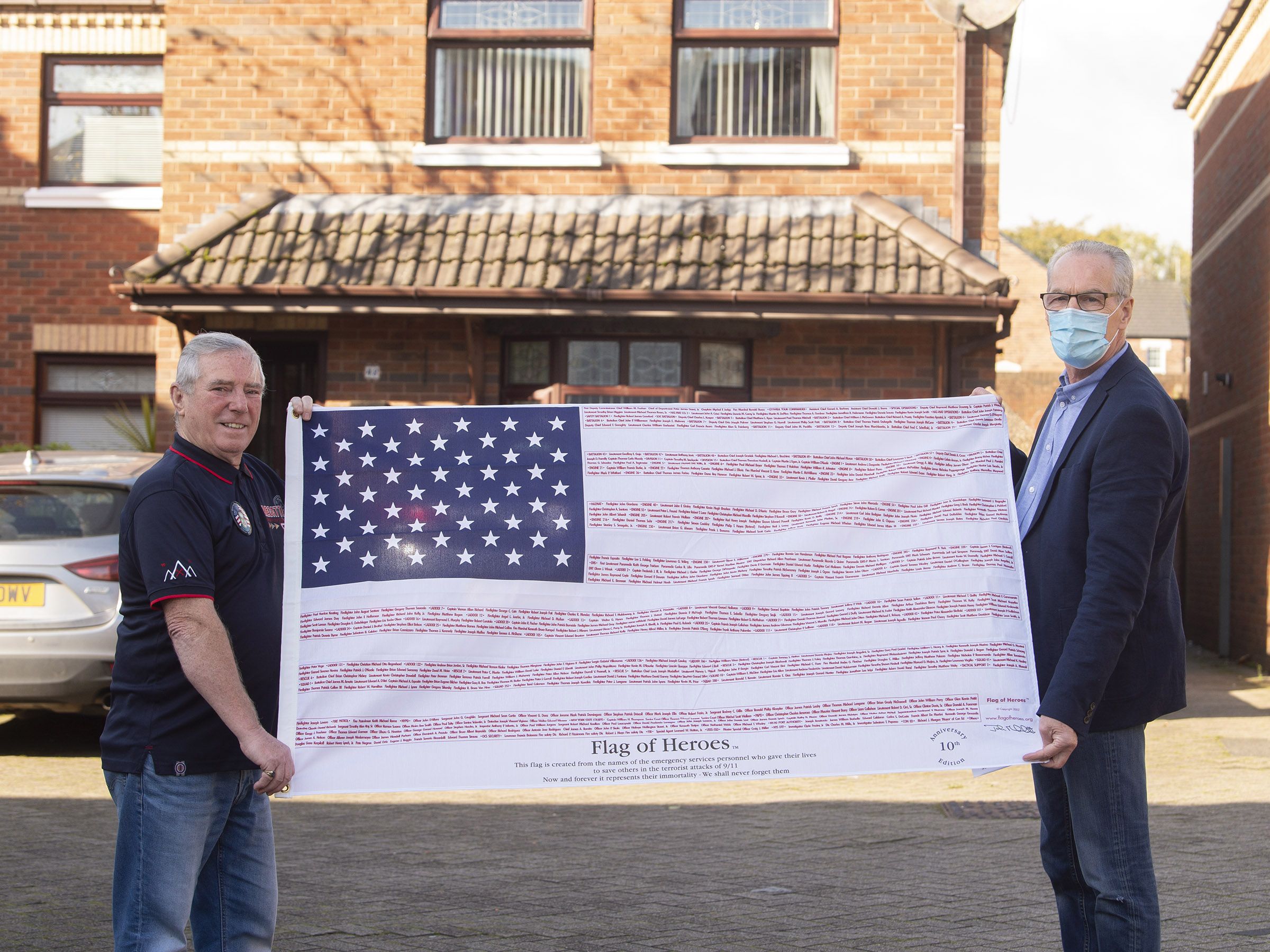 TRACKED DOWN: Bobby Quinn and Gerry Kelly with the flag commemorating 9/11 heroes