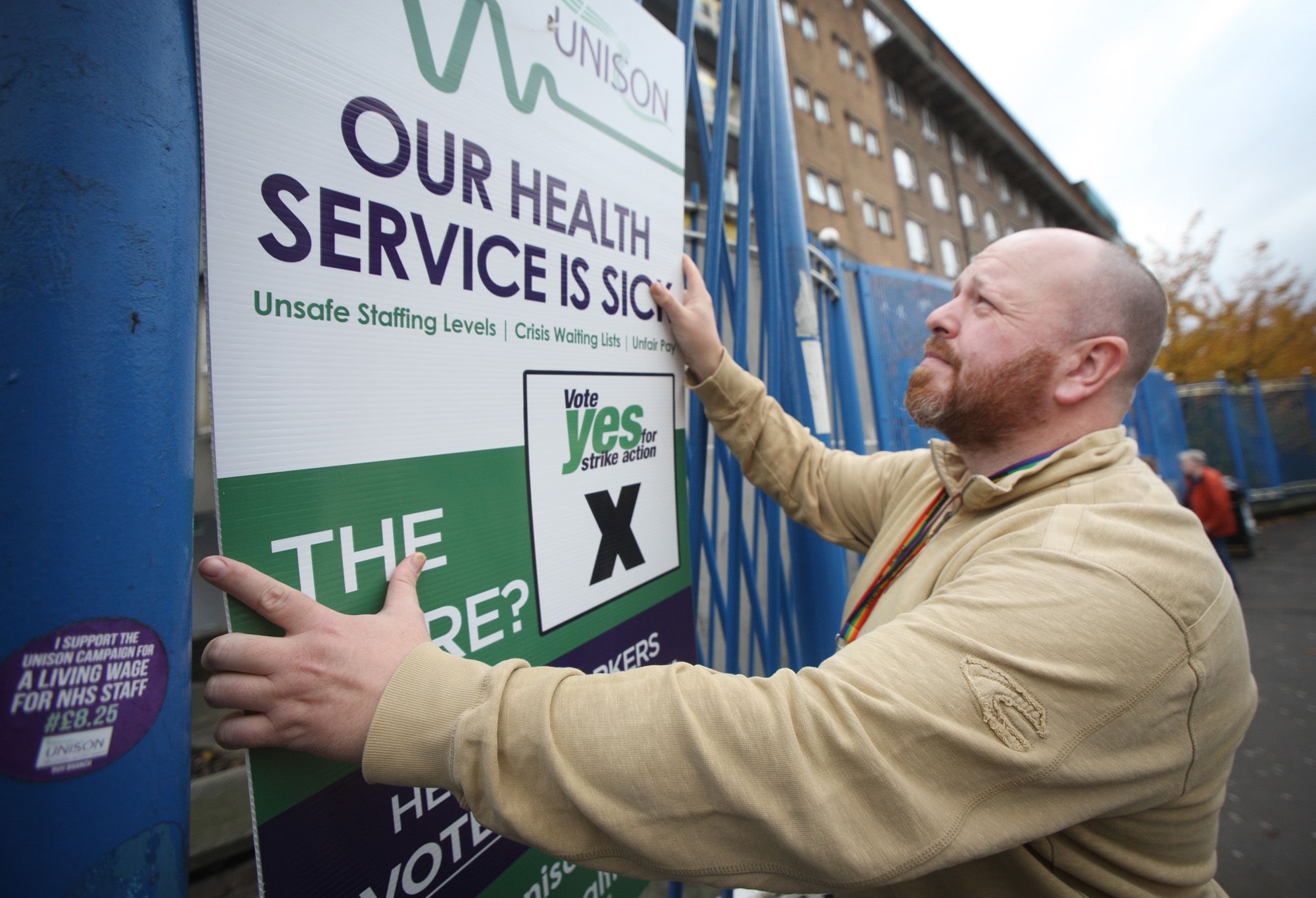 WARNING: Conor McCarthy puts up a poster at the RVH ahead of last year\'s health strike