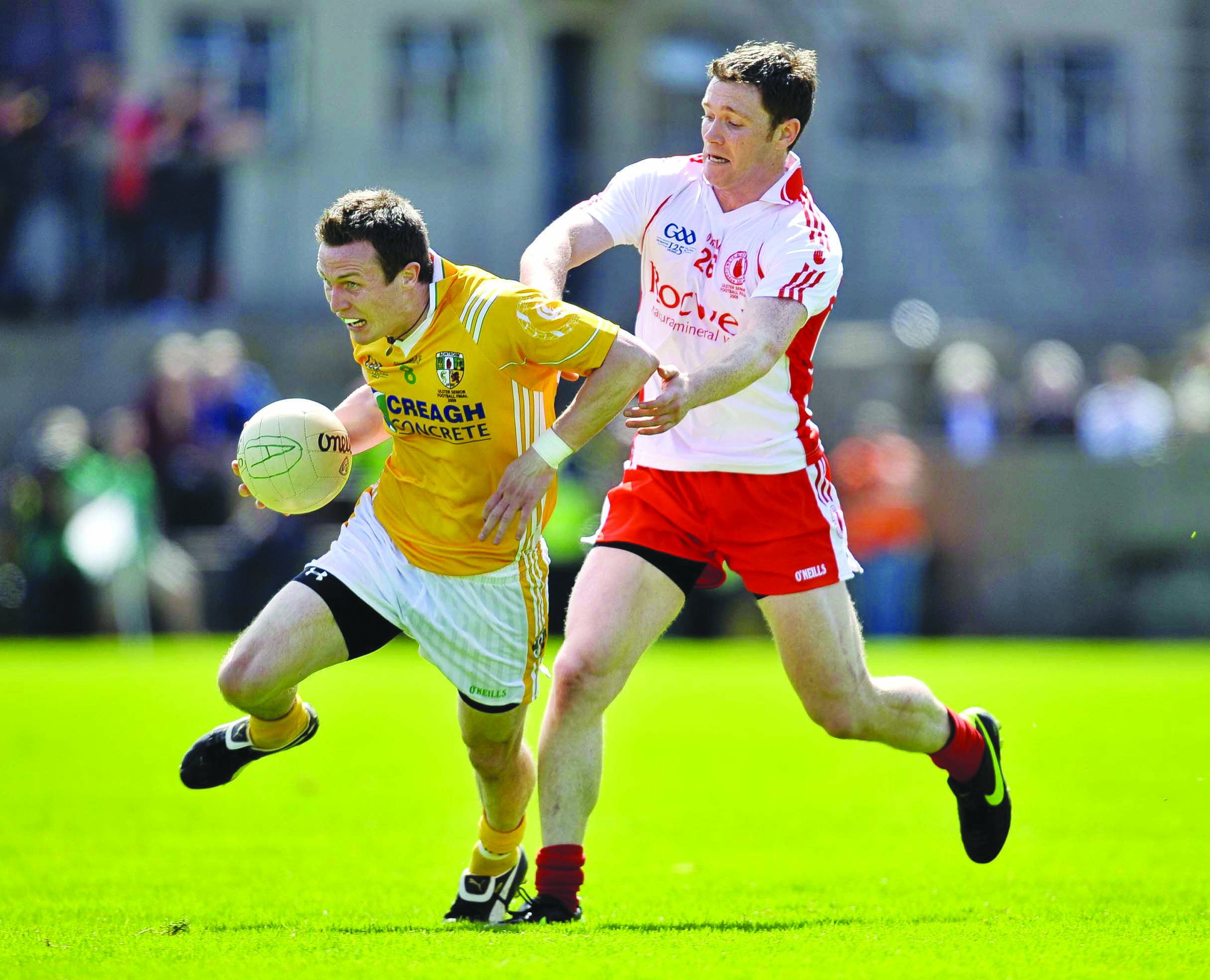 Three-time All-Ireland winner Enda McGinley, pictured challenging his brother-in-law Michael McCann during the 2009 Ulster final, takes over from Lenny Harbinson as Antrim football manager and has included former Tyrone teammate Stephen O’Neill and ex-Saf