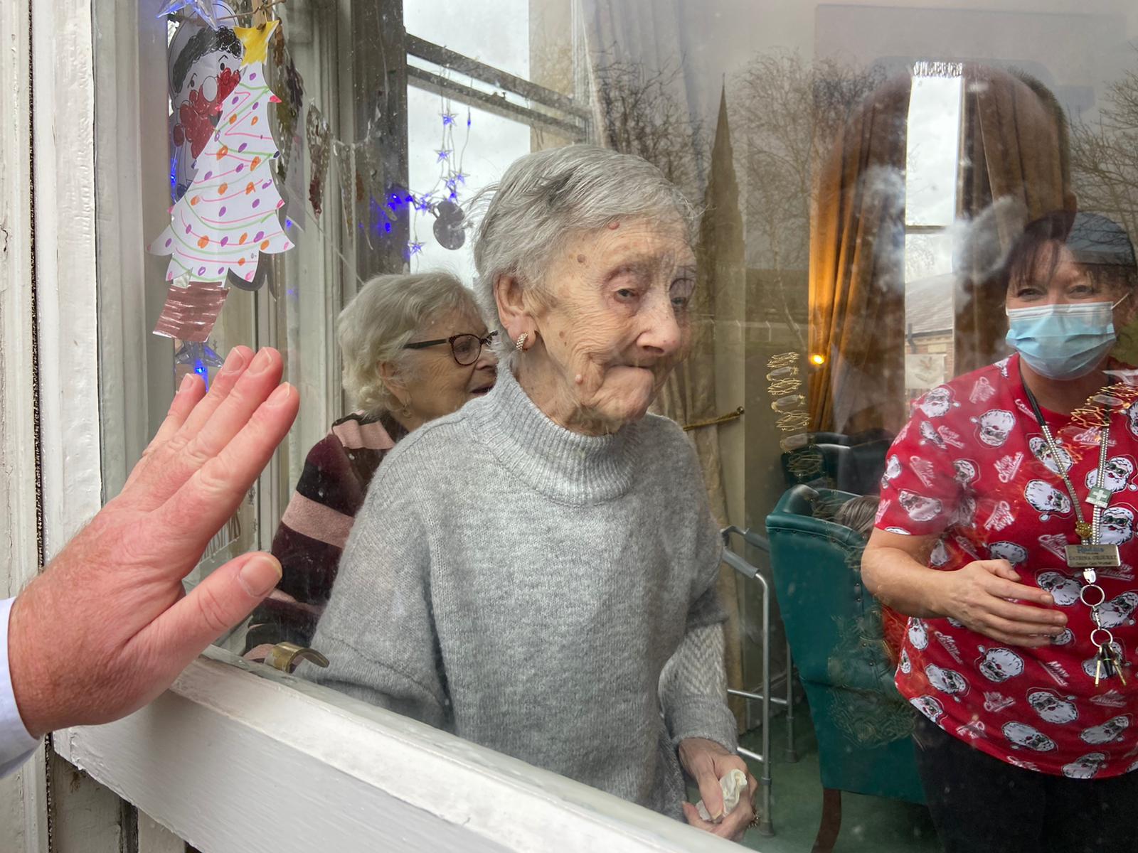 IN THIS TOGETHER EVEN AS WE STAY APART: Visitors spread Christmas cheer from outside Clifton House as residents enjoy their annual Yuletide luncheon