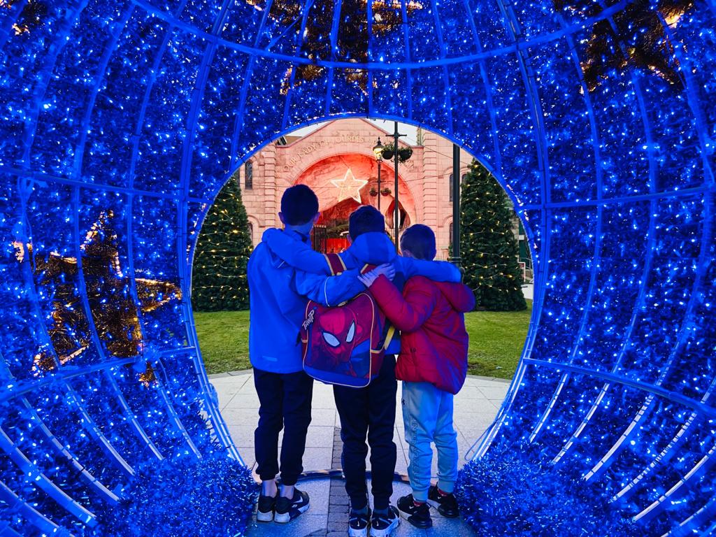FESTIVE: Three school friends look at the Christmas scene through the beautiful blue bauble