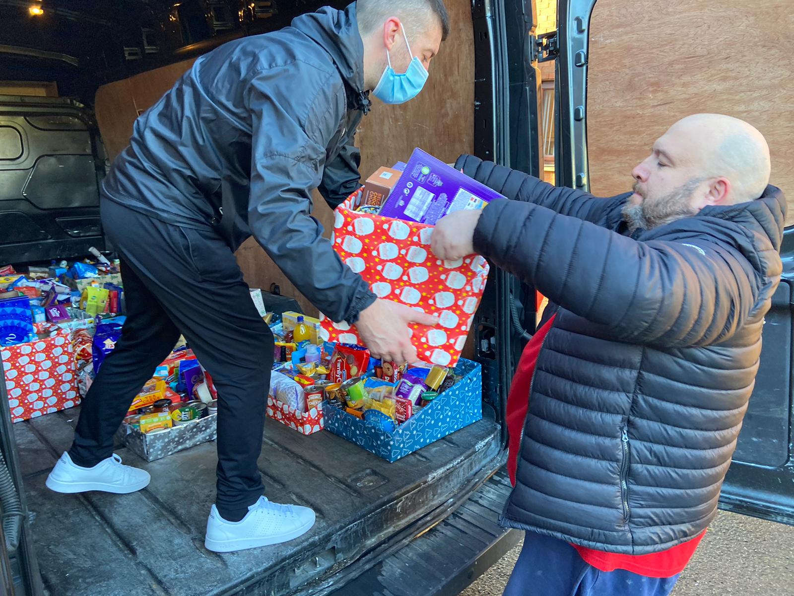 CHRISTMAS SPIRIT: Collecting the hampers at St Oliver Plunkett Parish Centre