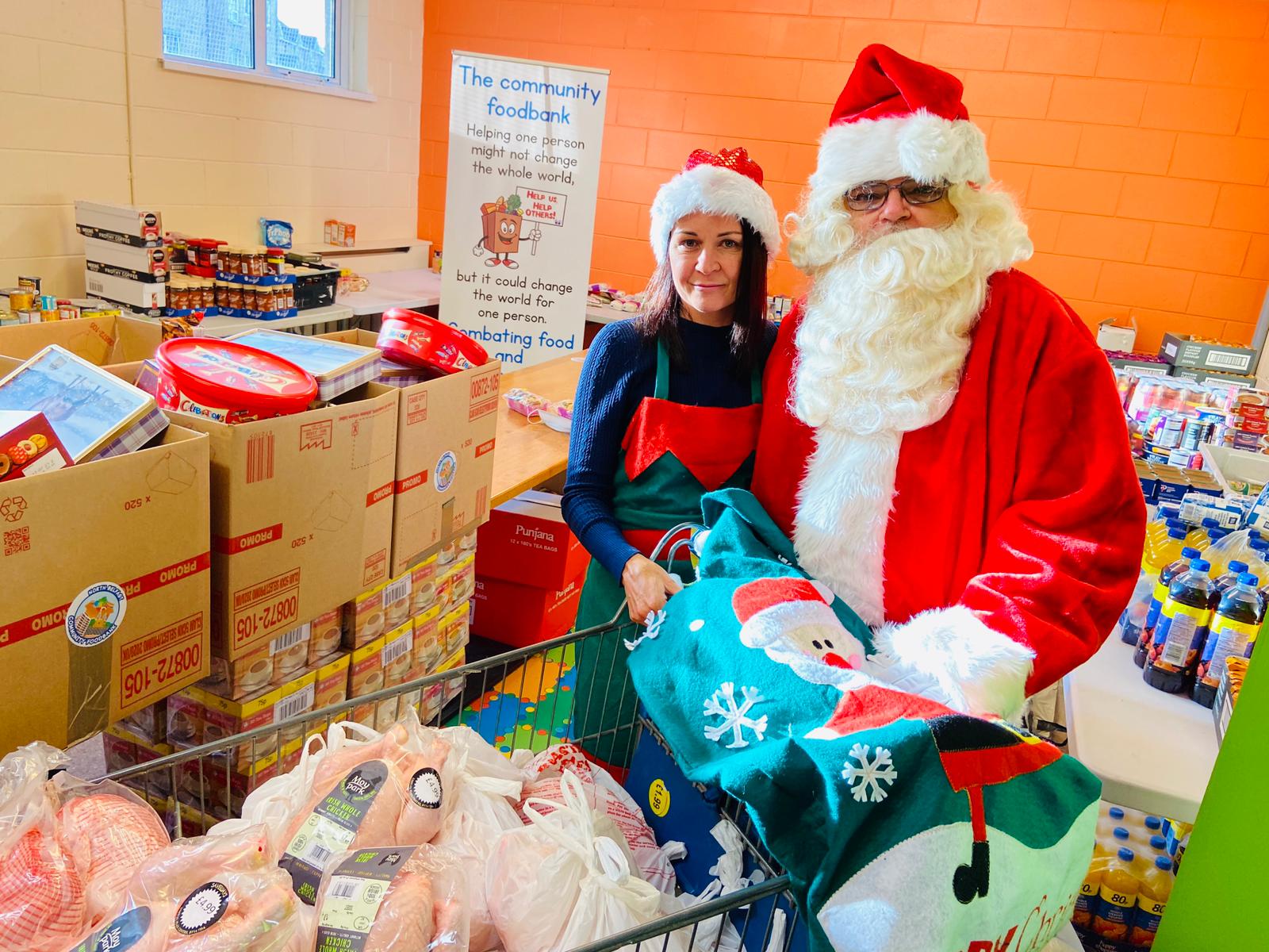 TEAMWORK: Nichola Bradley, Co-Ordinator of the Community Food Bank in Ardoyne with Santa