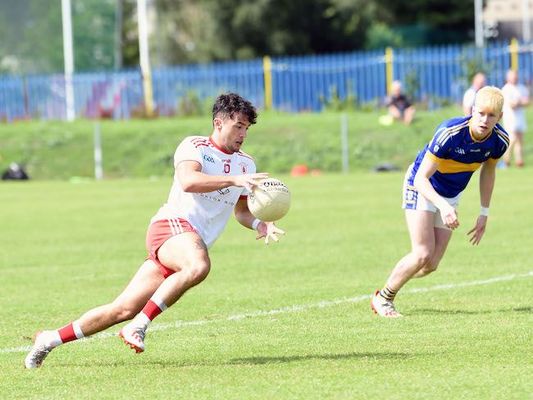Eoin McKeown bursts past Cormac McGettigan