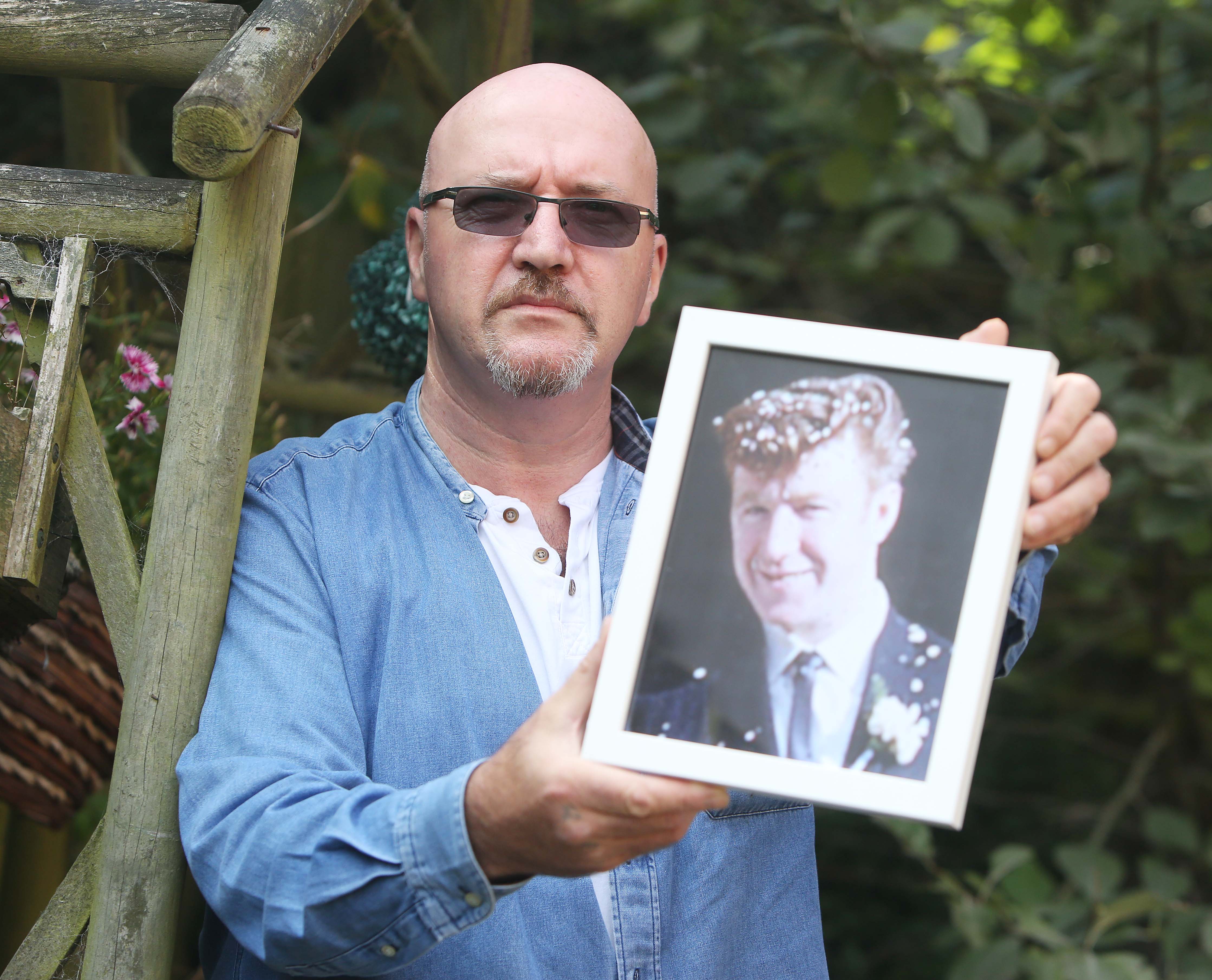 CRUSHED: Sam McLarnon holds a photograph of his father, Samuel, who was shot dead by the RUC on August 15 1969