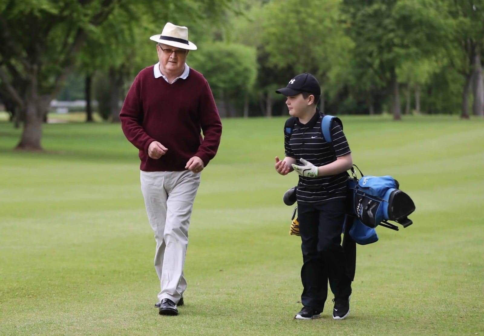 HOLE IN ONE: Aaron and his grandfather Kevin walk the course