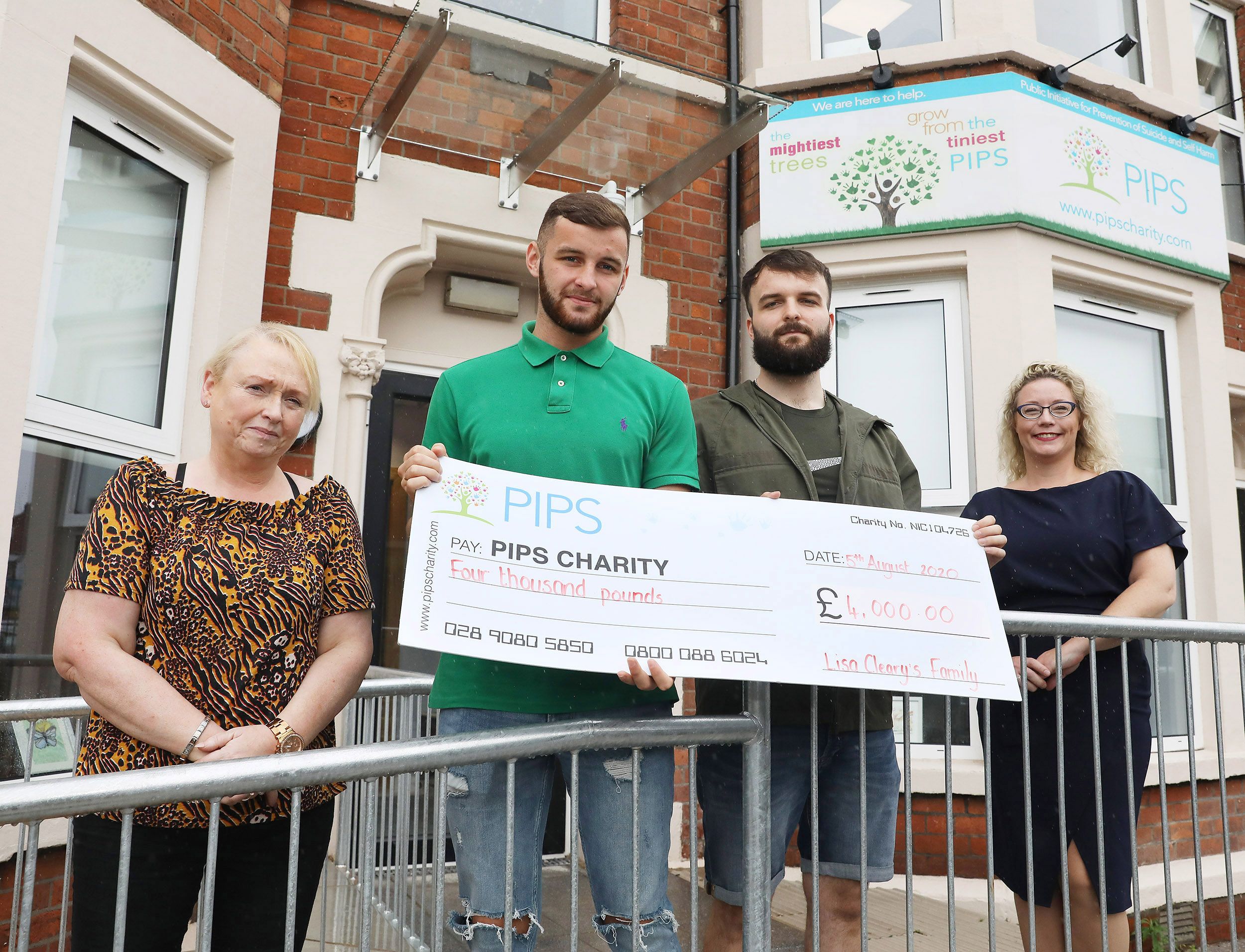 IN MEMORY: Lisa\'s sons Jamie and Nathan present a cheque for £4000 to Martina McIlkenny (Care Team Manager) and Renee Quinn (Director) of PIPS Charity on the Antrim Road
