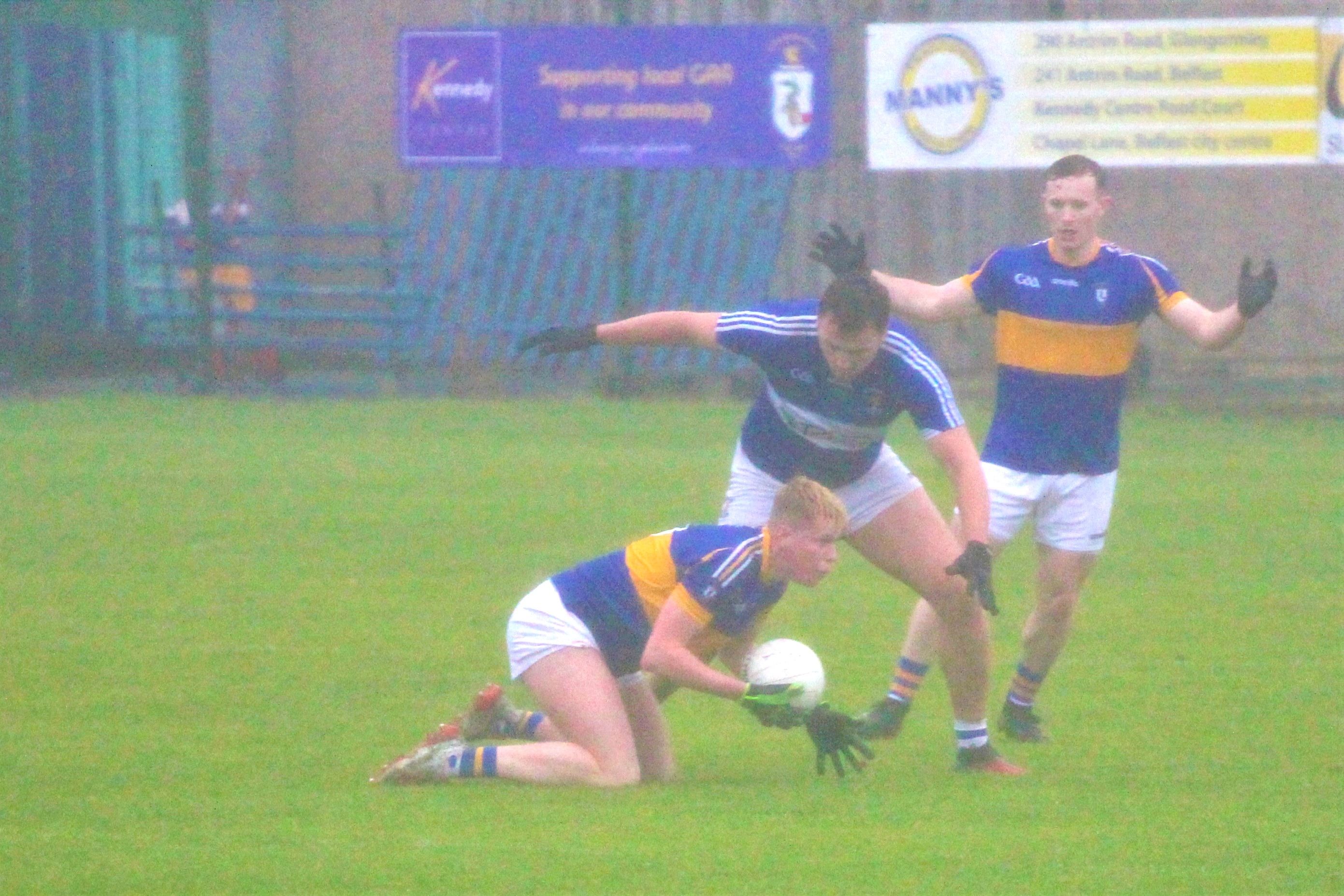 Cormac McGettigan looks for a pass as Domhnall Nugent challenges