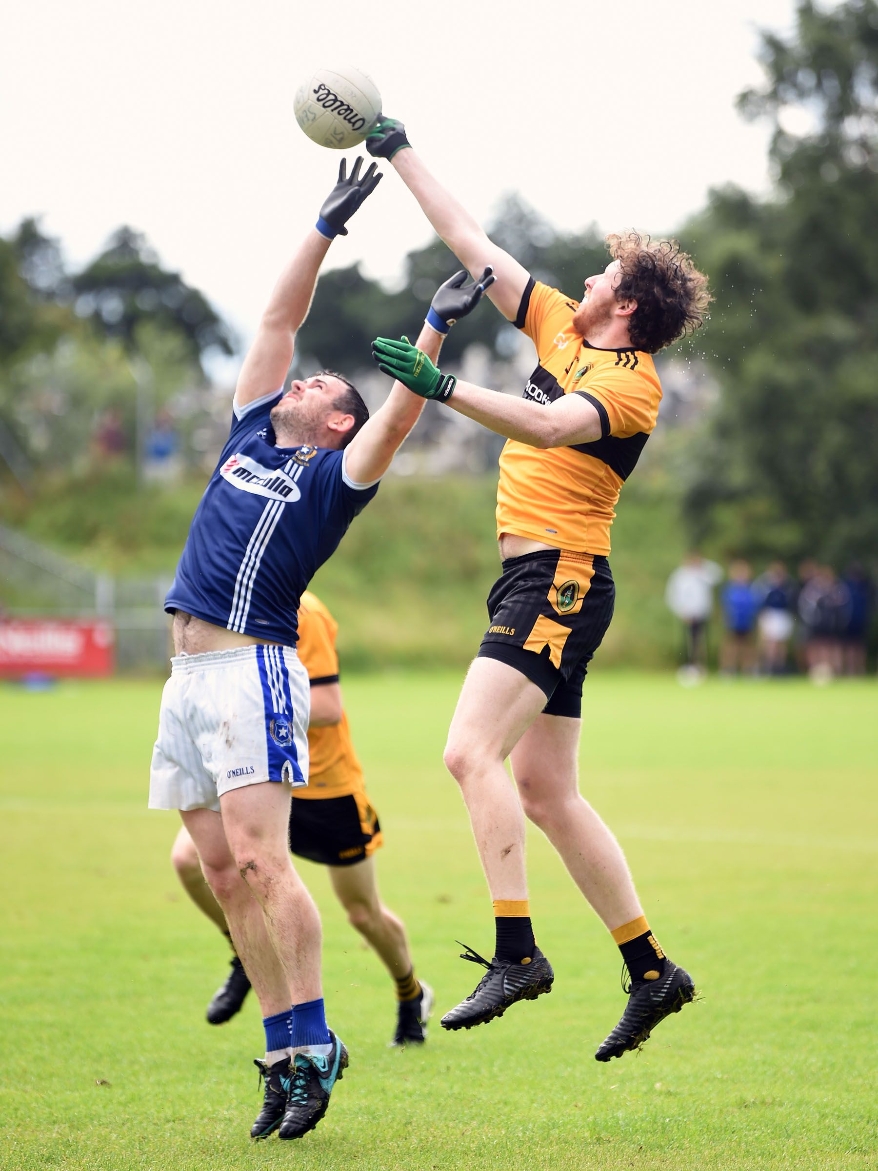 Naomh Éanna midfielder Niall McKeown fists the ball clear of Sean Burke of St Gall\'s when the sides met earlier this month 