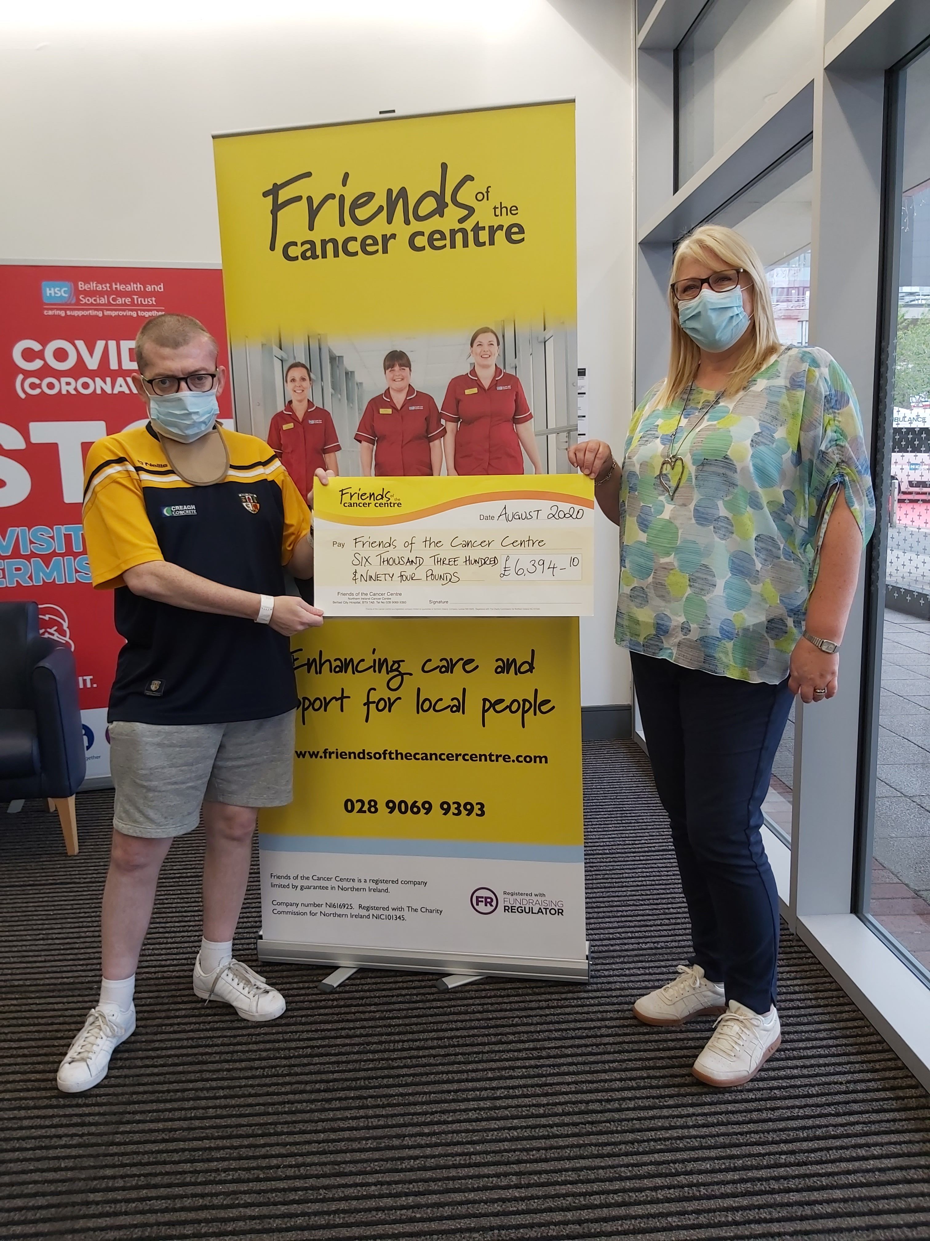 GREAT JOB: Michael O’Neill presents Ana Wilkinson of Friends of the Cancer Centre with a cheque for £6394.10