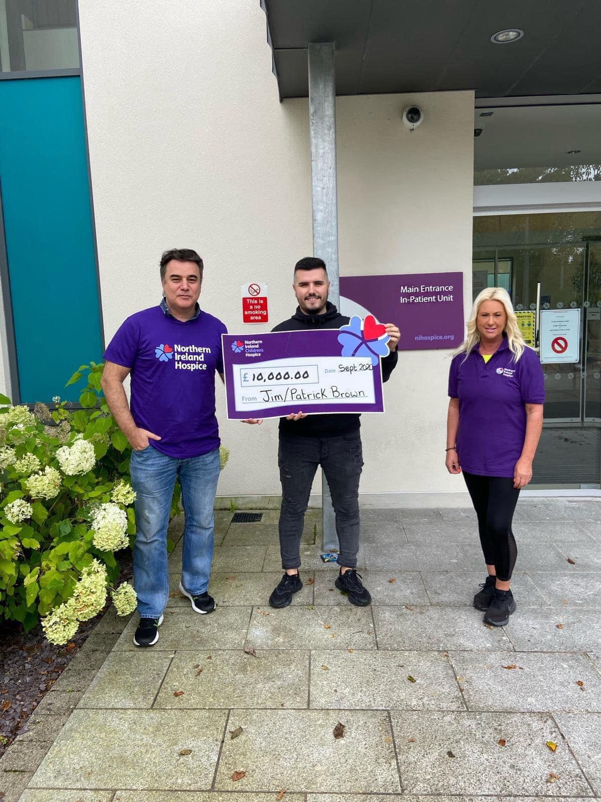 CHARITY BOOST: Jim Brown and his son Pádraig present a cheque for £10,000 to Noreen Kennedy from NI Hospice – the funds were raised from the highly popular Saturday night concerts that the pair put on during lockdown
