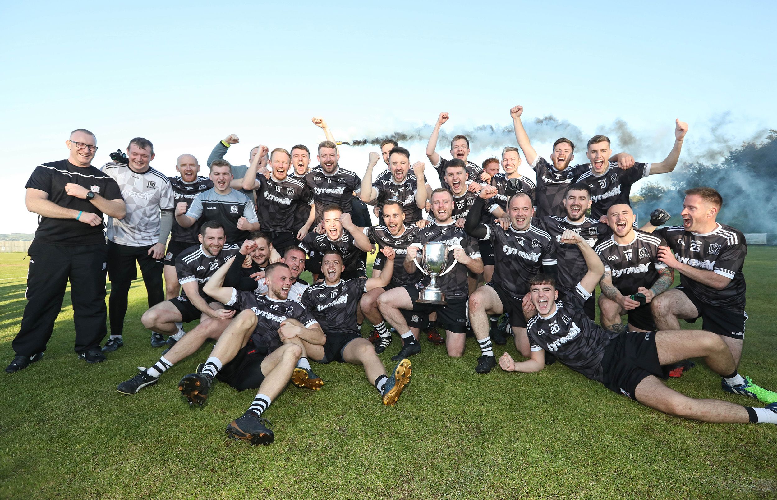 Ardoyne players celebrate with the cup after they claimed the club\'s first Junior Football Championship title since 2012