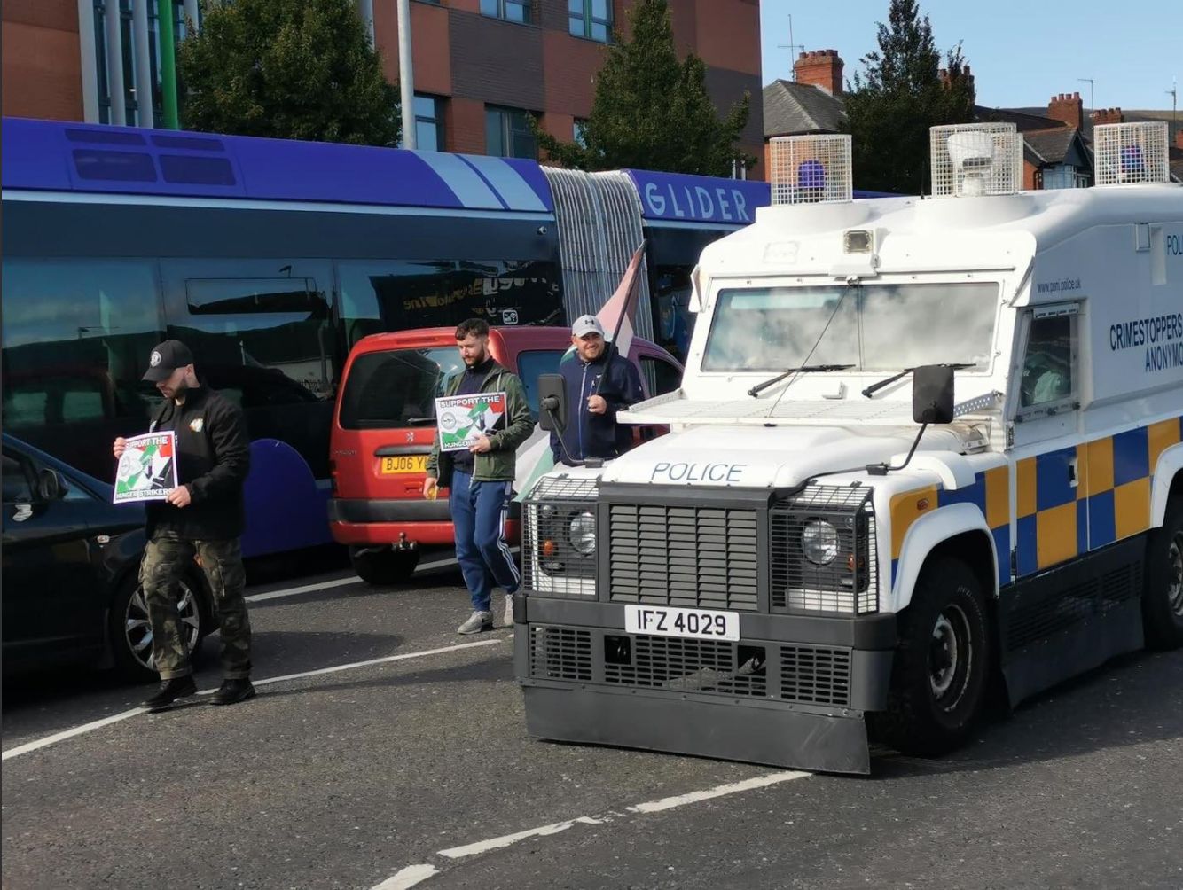 PROTEST: A PSNI Land Rover passes a white line picket on the Falls Road in support of the hunger strike