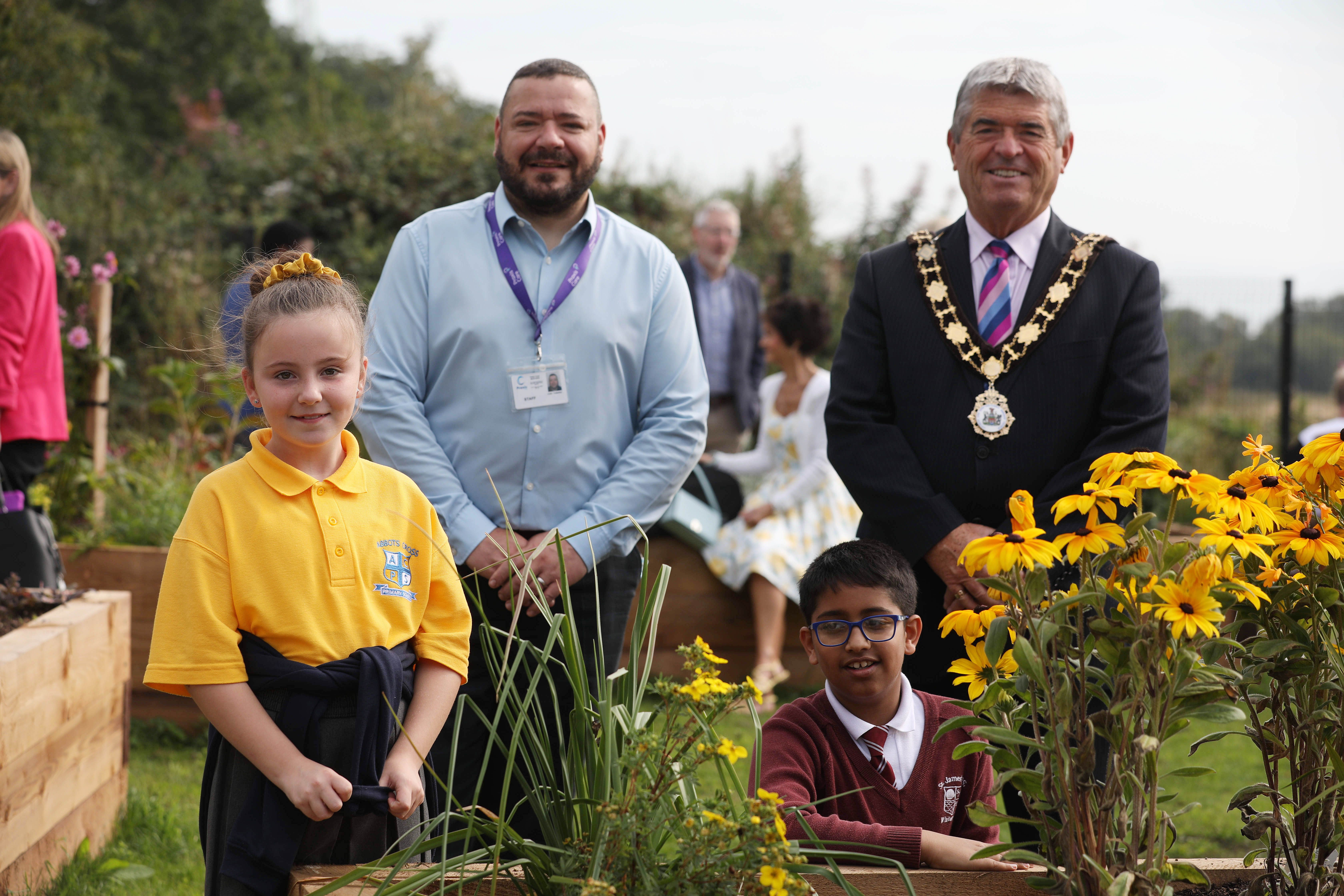 SENSORY GARDEN: Jessie from Abbott’s Cross Primary School and Joseph from St James Primary School who won the garden naming competition with Memory Lane, centre manager Colin Fullerton and Antrim and Newtownabbey Mayor, Cllr Billy Webb