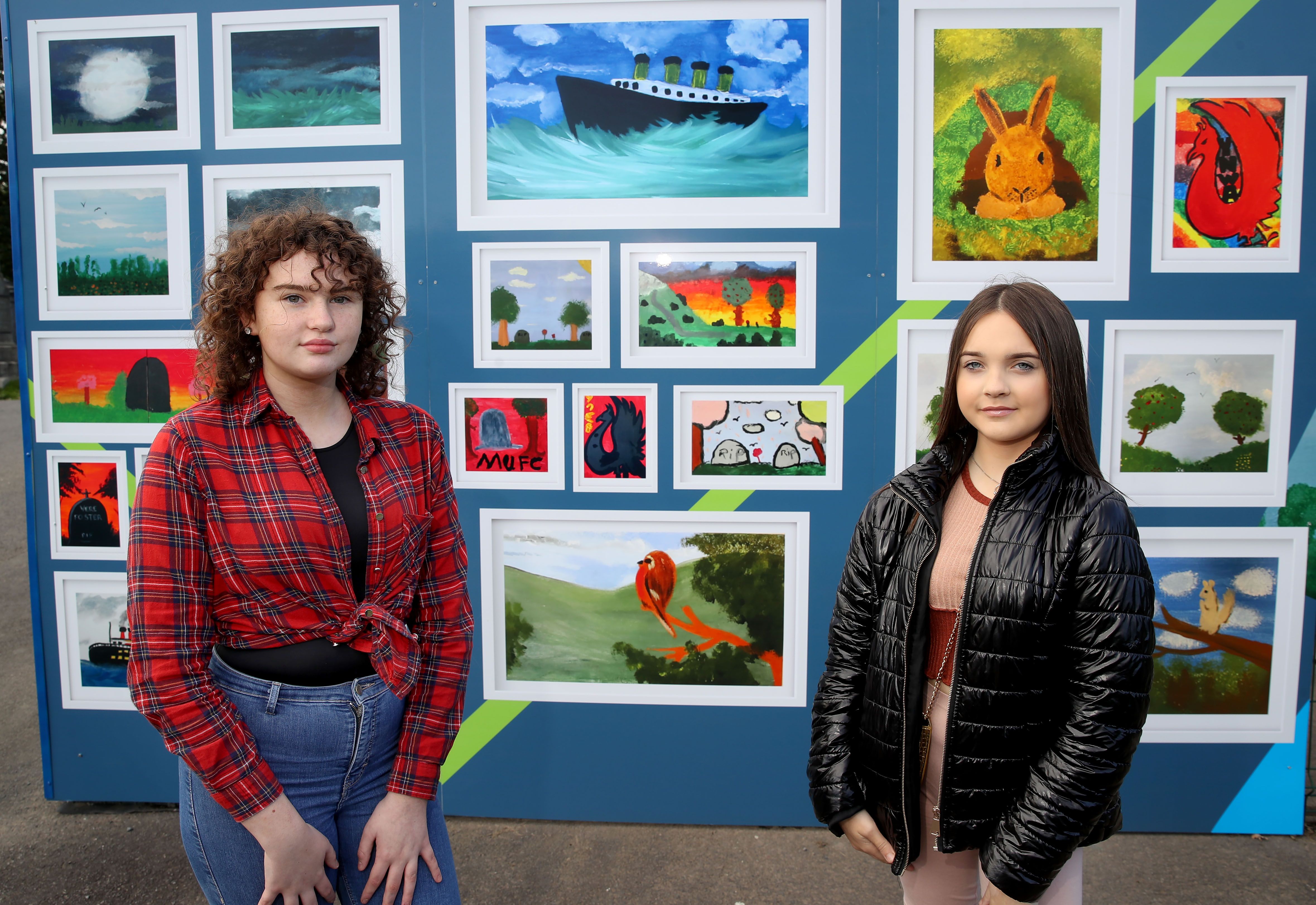 BRUSH STROKES: Budding artists Ella Connolly and Erin Lewsley from St Teresa’s Youth Club at the unveiling of heritage-themed artwork at Belfast City Cemetery