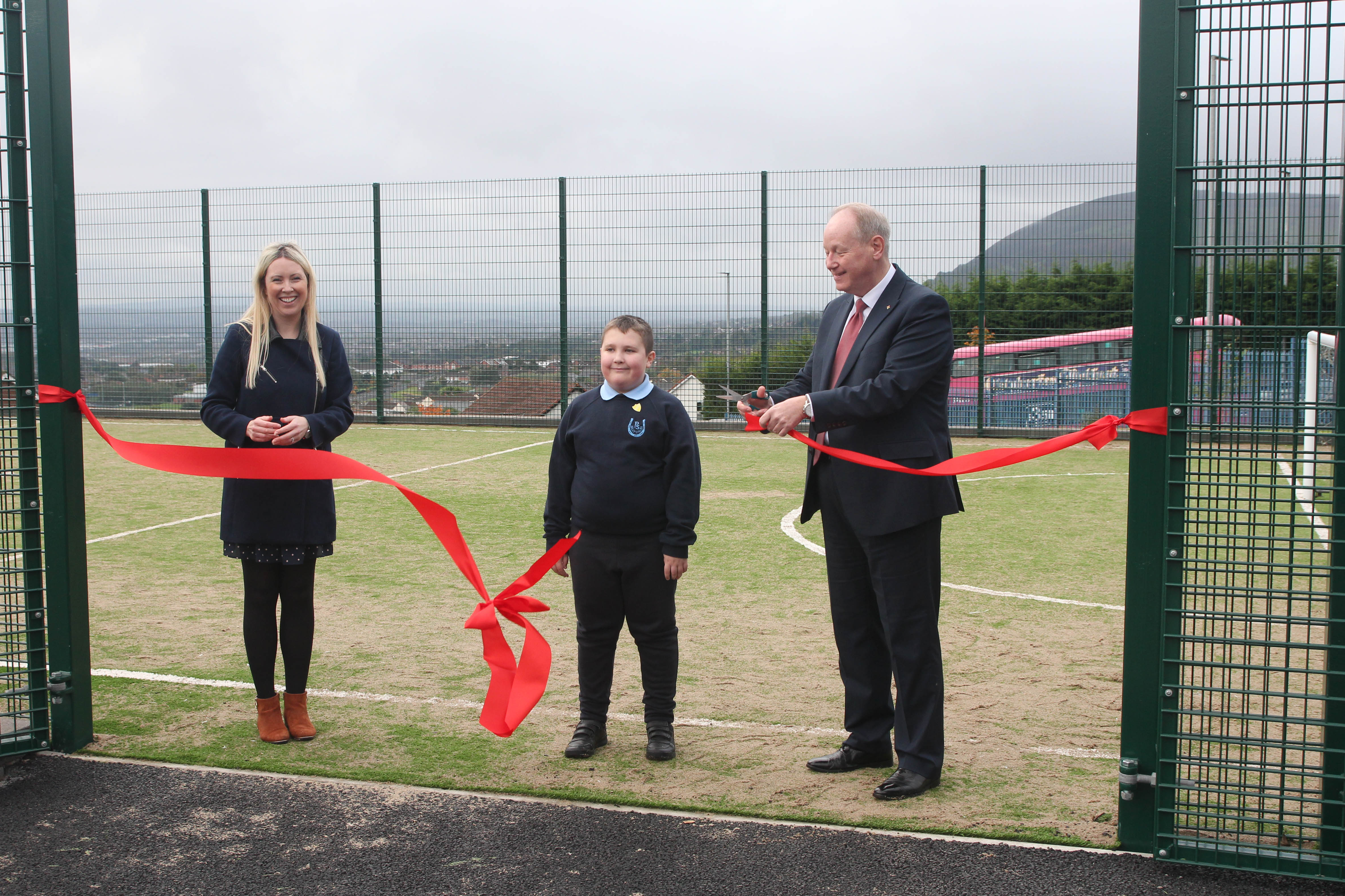 PLAYGROUND IMPROVEMENTS: William Humphrey MLA officially opens the new MUGA pitch and other playground enhancements at Ballysillan Primary School alongside Acting Principal Catherine Davidson and P7 pupil Mason.  