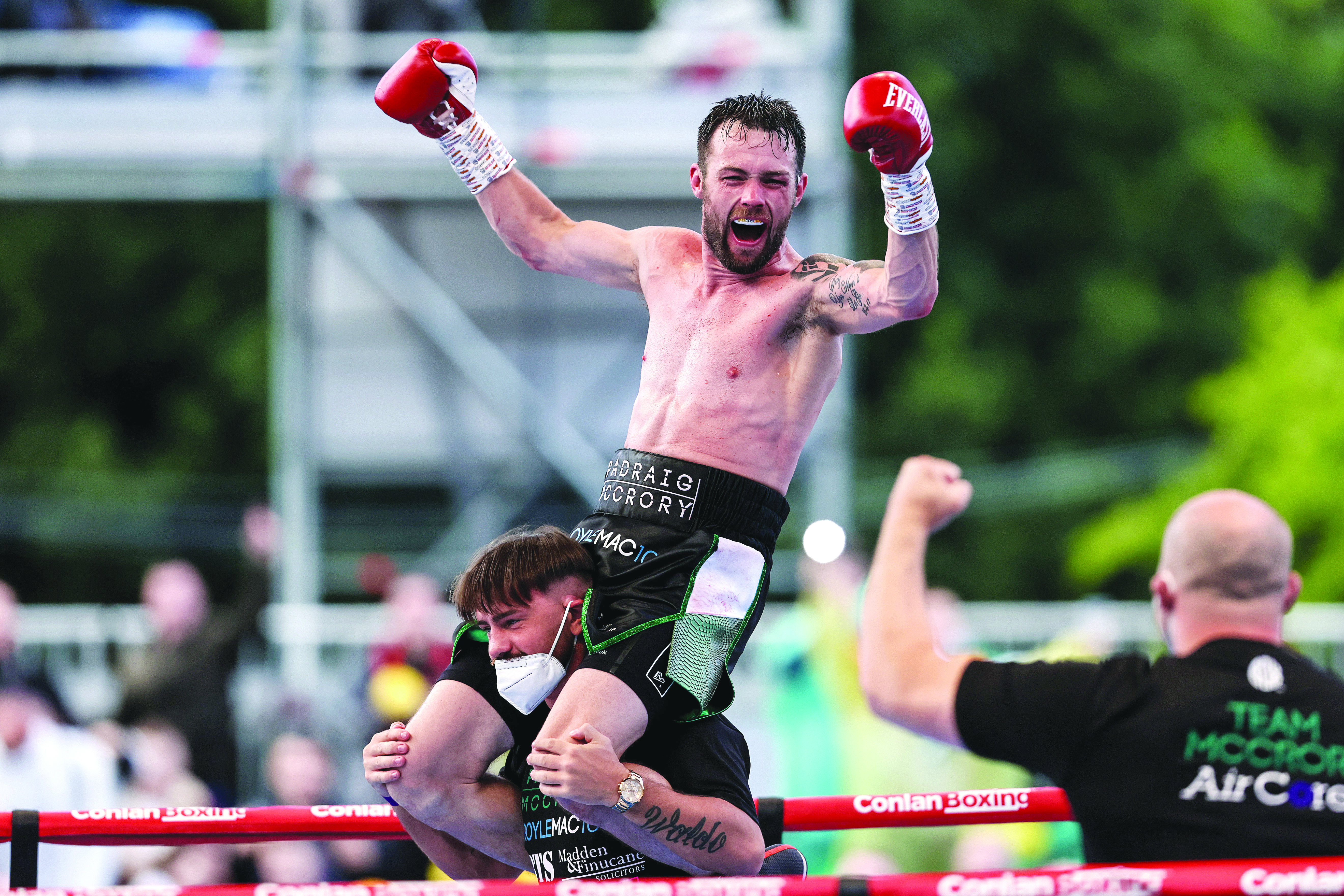 Padraig McCrory is chaired around the ring by trainer Dee Walsh following his win over Sergei Gorokhov at the Falls Park in August