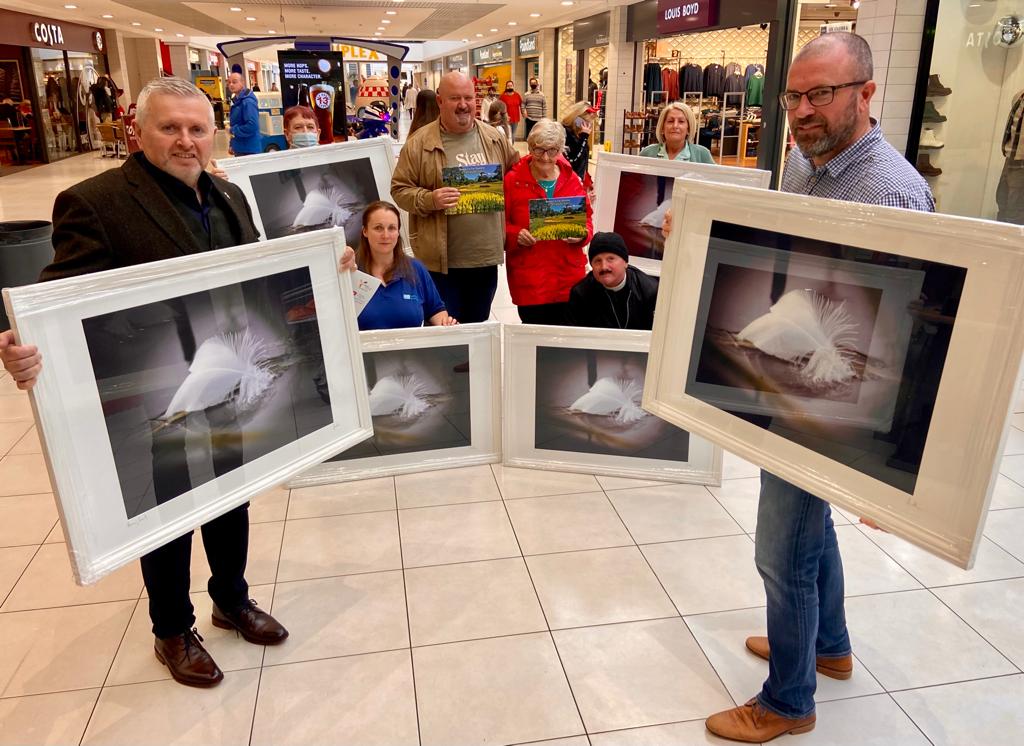 IN THE FRAME: John Mallon (centre) presents photos to frontline workers during the launch of his annual charity calendar 