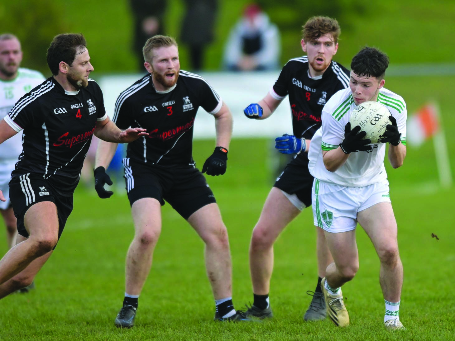 St Comgall’s attacker Tom Patchett tries to get clear of the St Agnes’ defence during Sunday’s Junior Football Championship semi-final at Glenavy