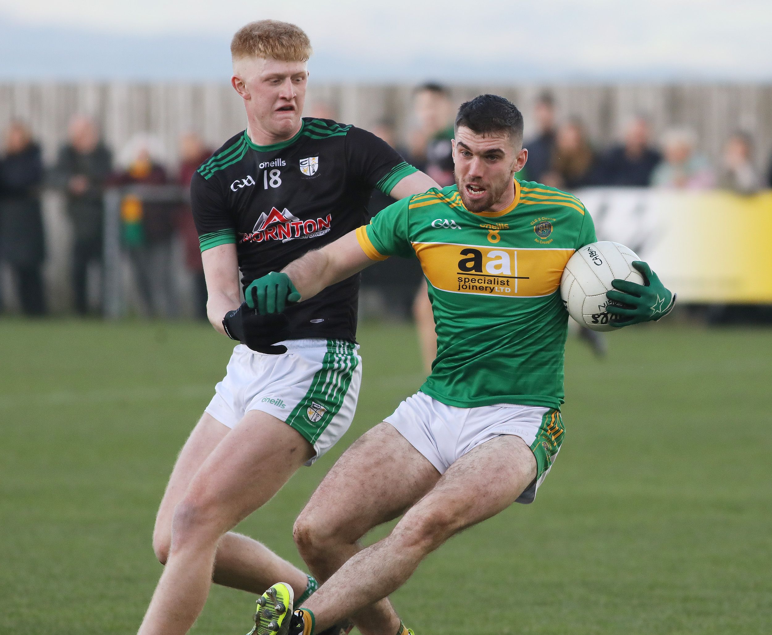 Creggan\'s Kevin Small tries to evade the challenge of Cargin midfielder Pat Shivers during Sunday\'s Antrim SFC semi-final at Naomh Éanna 