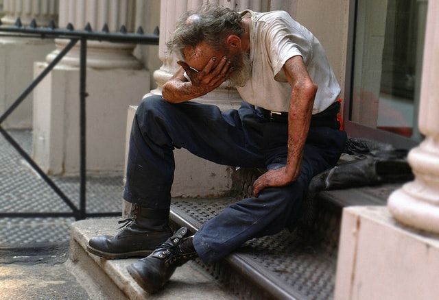 \"COMPASSION MOVES ME TO ACTION\": A homeless man in distress in New York. 