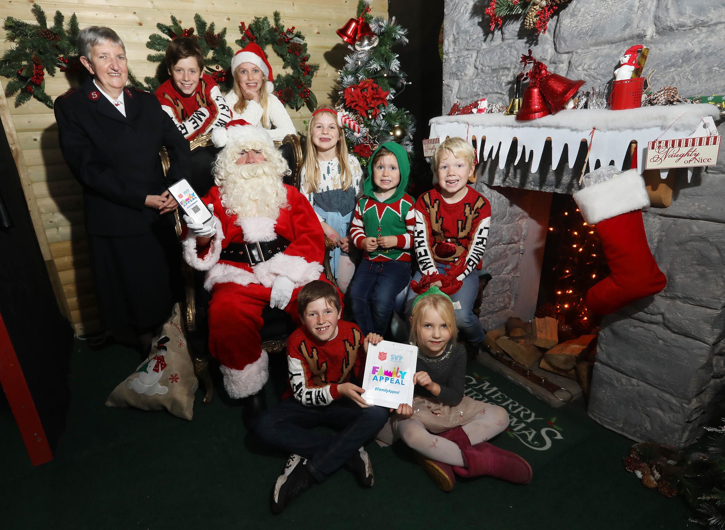 APPEAL: Cousins Joshua Ward (9), Mia Forsyth (9), Olivia Forsyth (7), Micah Ward (4), Jacob Ward (6), Reuben Ward (8) and Evie Forsyth (5) and Major Jacqueline Wright of The Salvation Army launch this year\'s Christmas Family Appeal