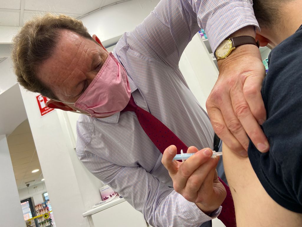 MESSAGE: Dr Terry Maguire administers a vaccine at his pharmacy