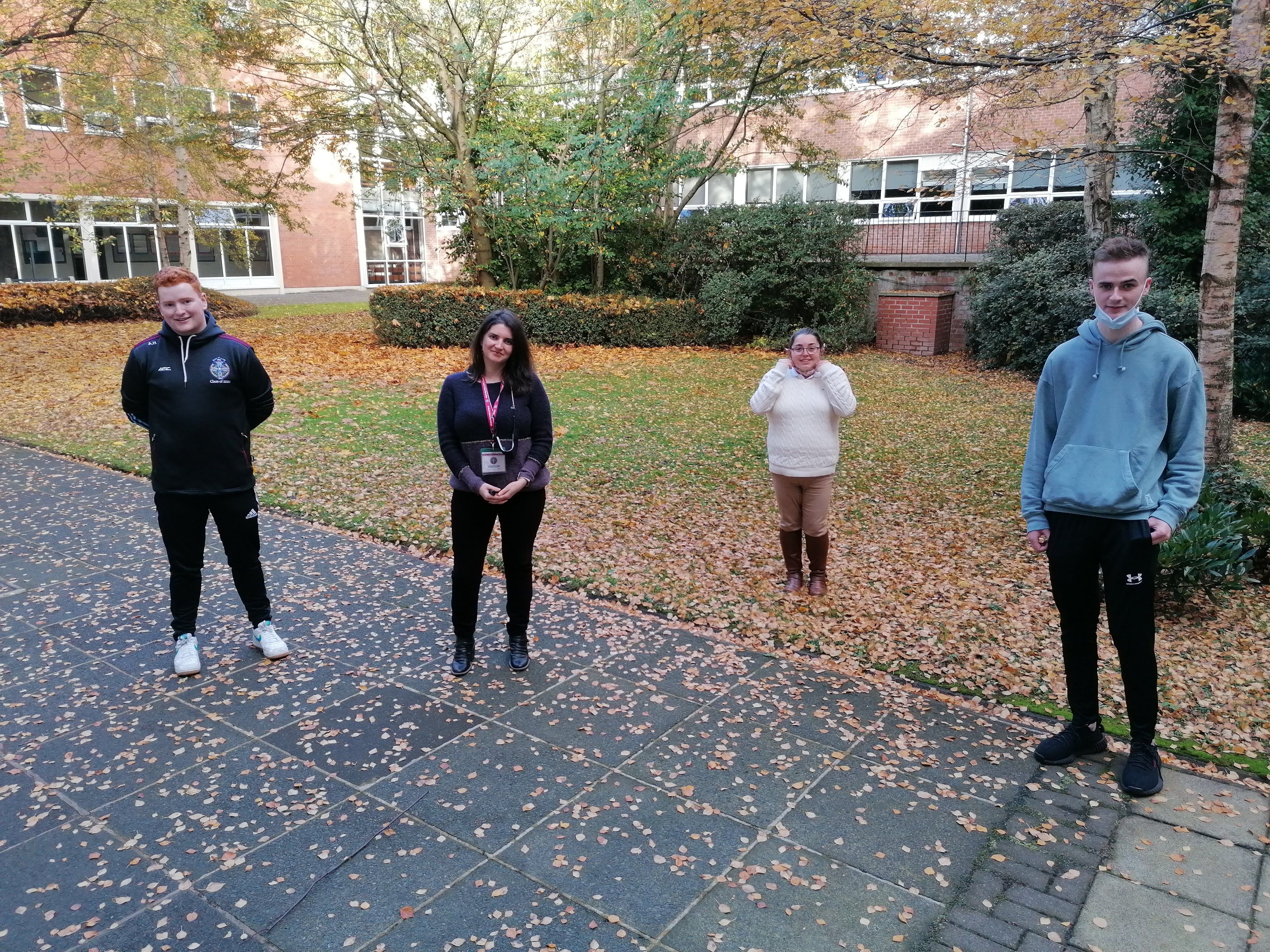 GIVING BACK: Year 2 B. Ed. students Andrew Harkin, Patrick McKillen and Emer Feeney with Laura Rio Fernandez of Trόcaire 