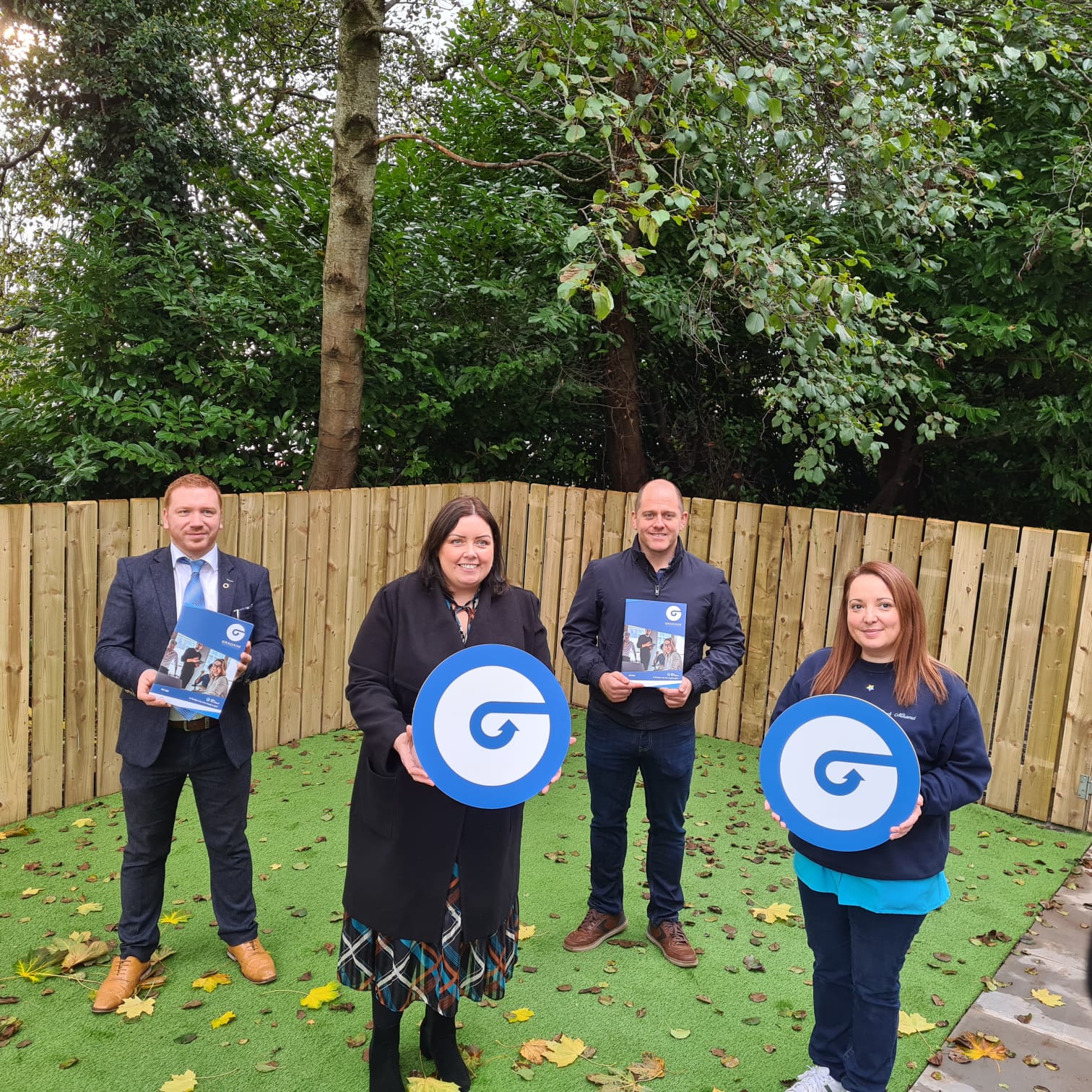 Glór na nGael Development Manager Frainc Mac Cionnaith, Communities Minister Deirdre Hargey, Glór na Móna Director Feargal Mac Ionnrachtaigh, and Teach Mhamó founder Nuala McCusker