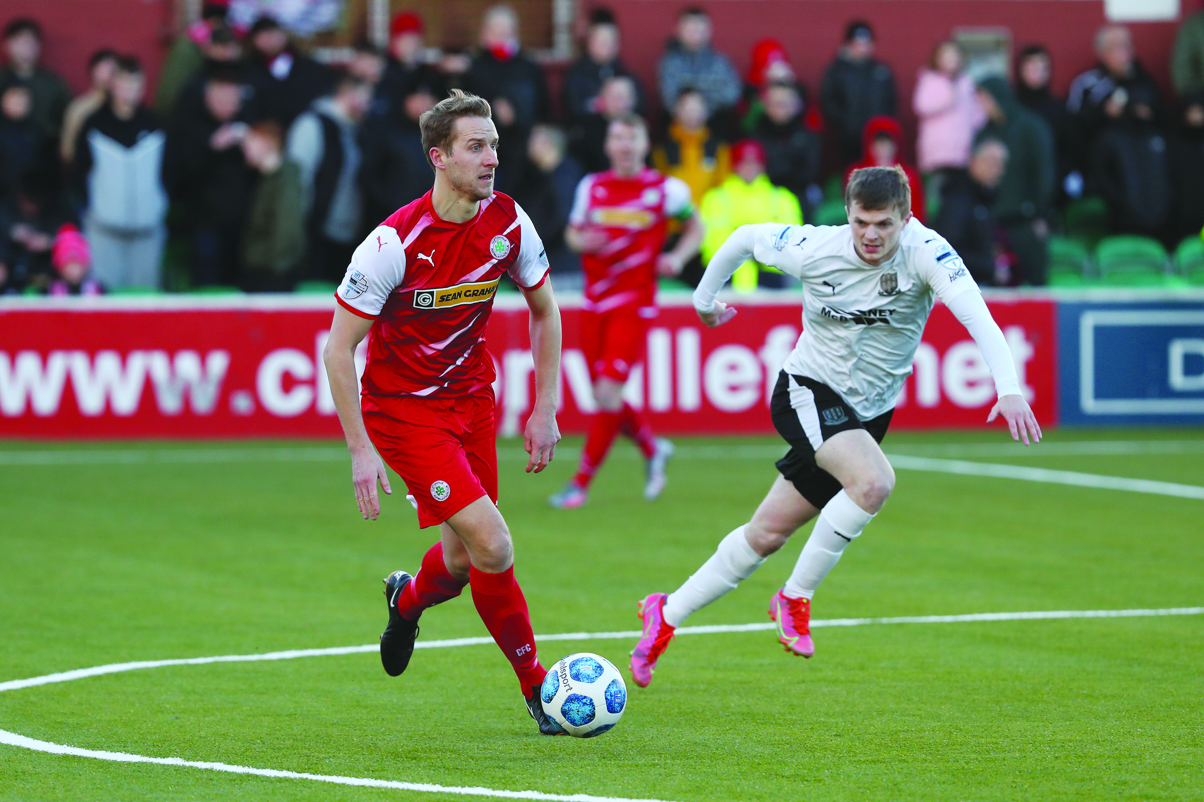 Cliftonville’s Jonny Addis with David Parkhouse of Ballymena during last Saturday’s clash at Solitude and the Reds will seek to continue their fine league form at Portadown this weekend 
