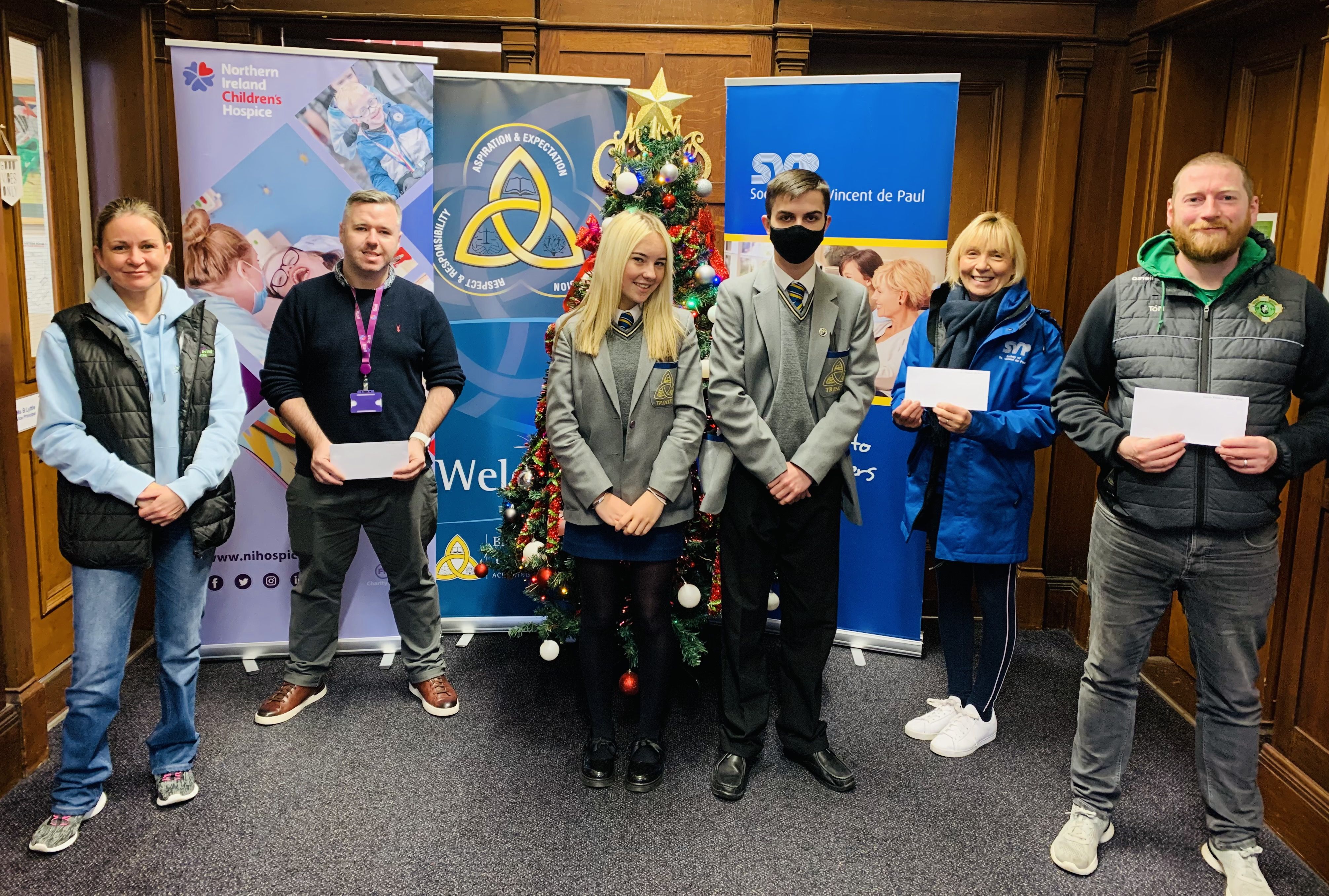 CHRISTMAS FUNDRAISING: Staff of Blessed Trinity College with representatives from the Northern Ireland Hospice, St Vincent de Paul and North Belfast Community Food Bank