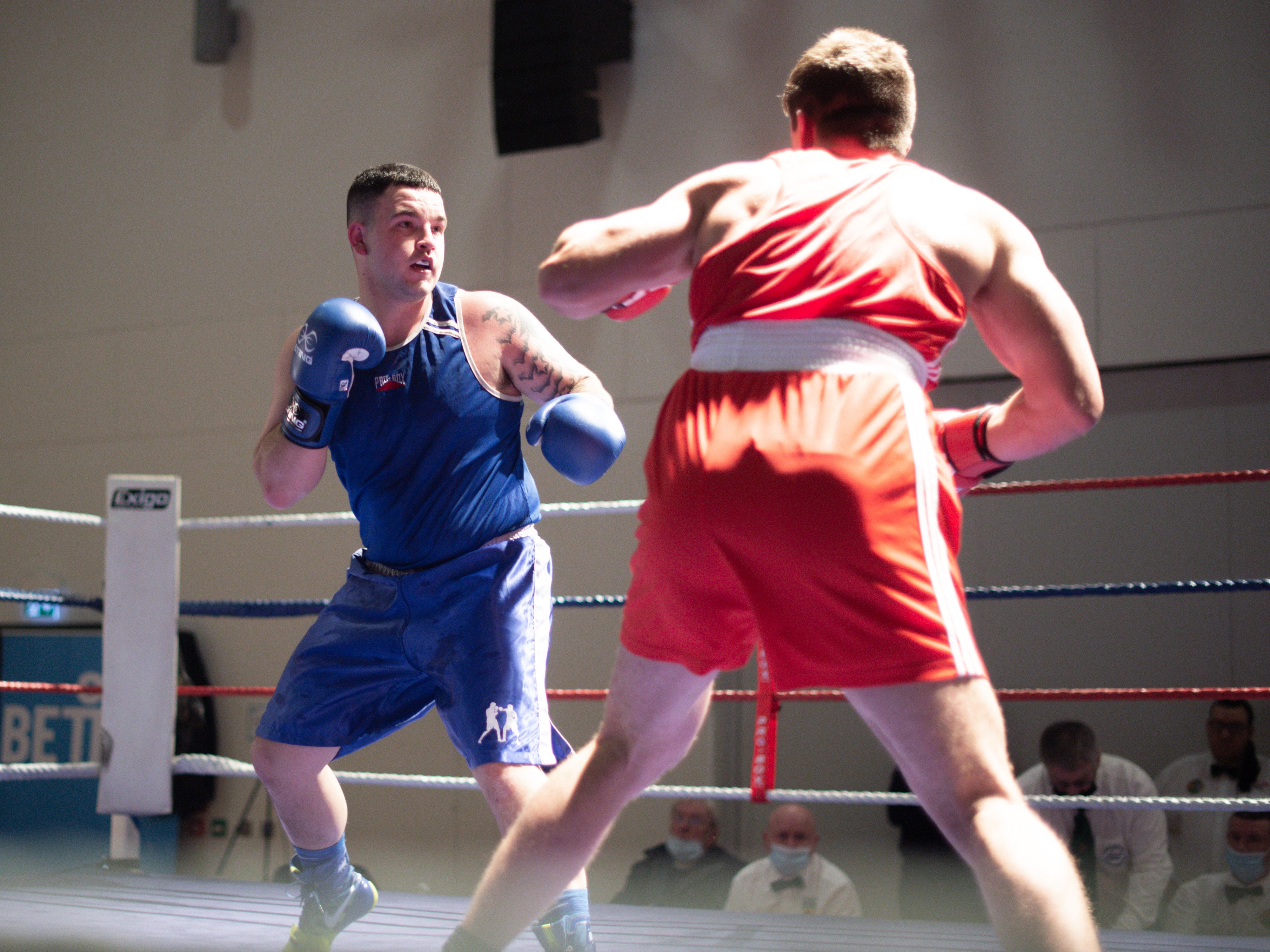 BOUT: Stephen McMullan (in blue) fell ill after defeat by Charlie Boyle in the heavyweight decider in the Ulster Elite Amateur Finals at Girdwood Community Hub last Thursday