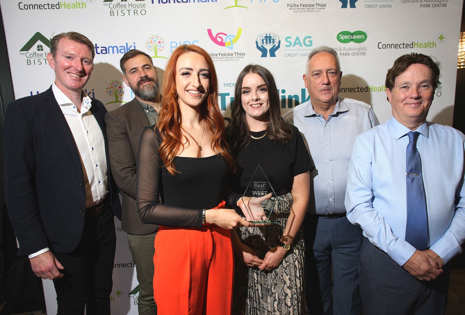 COMHGHAIRDEAS: Clíodhna Ni Bhranair, foreground, joins the team from Áras Uí Chonghaile and Damien Bannon of Translink (left) to show off their Best of the West award