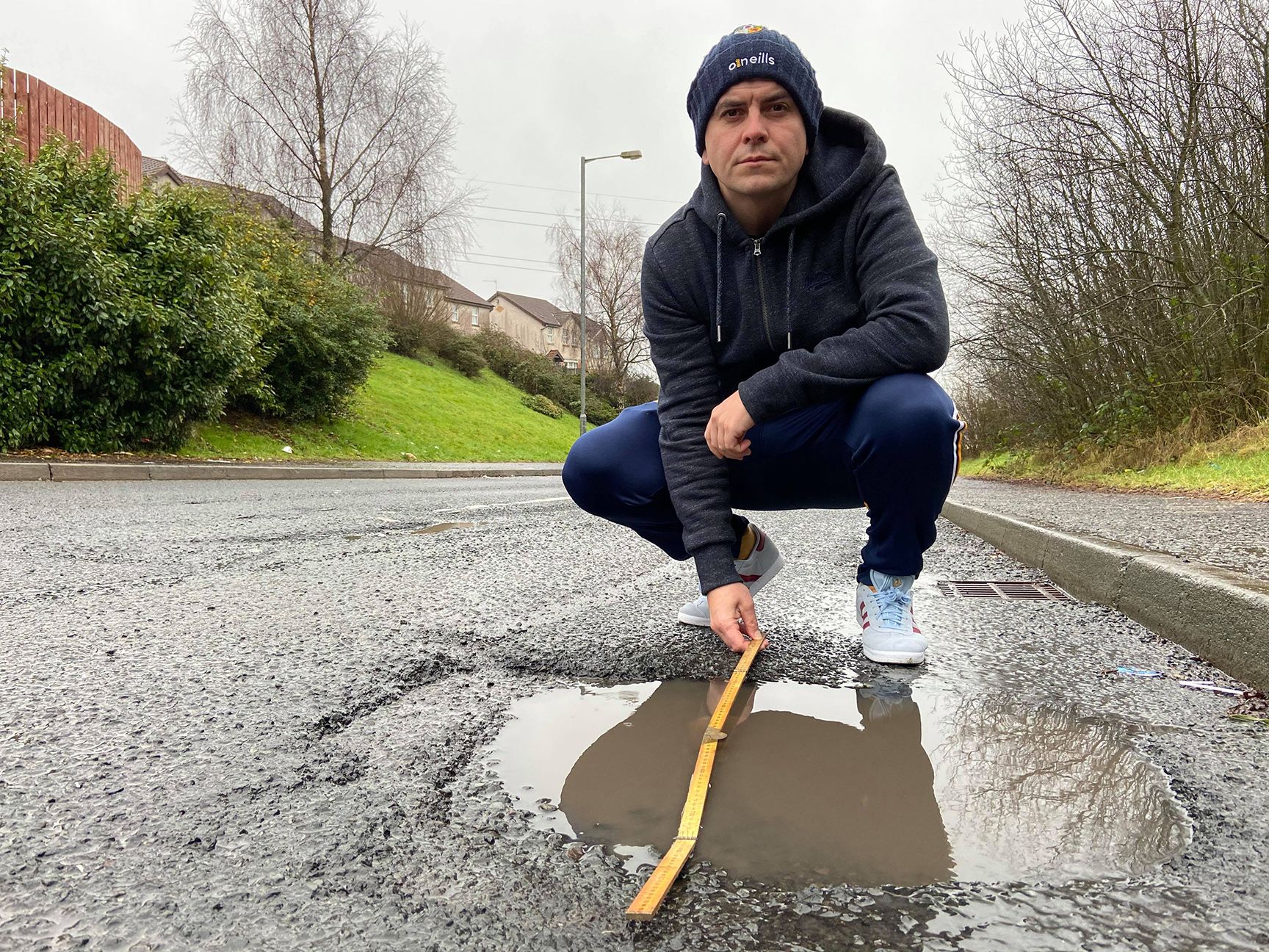 ROAD SAFETY: Sinn Féin councillor Danny Baker at one of the many potholes in Lagmore. A car hit a pothole at the weekend causing an accident