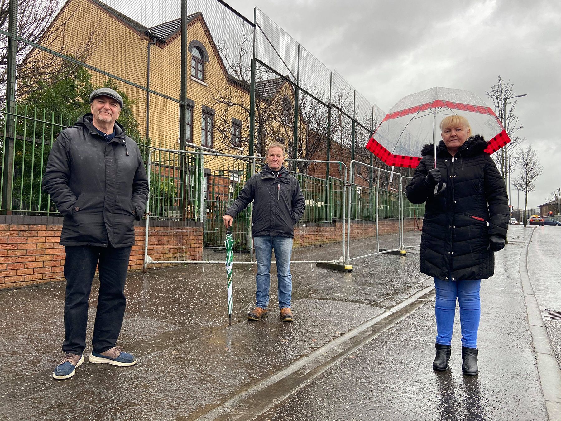 WELCOME: Gerry O’Reilly (New Lodge Housing Forum), Sinn Féin councillor JJ Magee and Kate Clarke (Duncairn Community Partnership) at the fencing which will come down