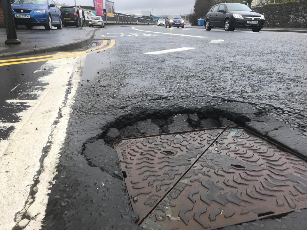 THAT SINKING FEELING: One of the sunken manhole covers in Andersonstown
