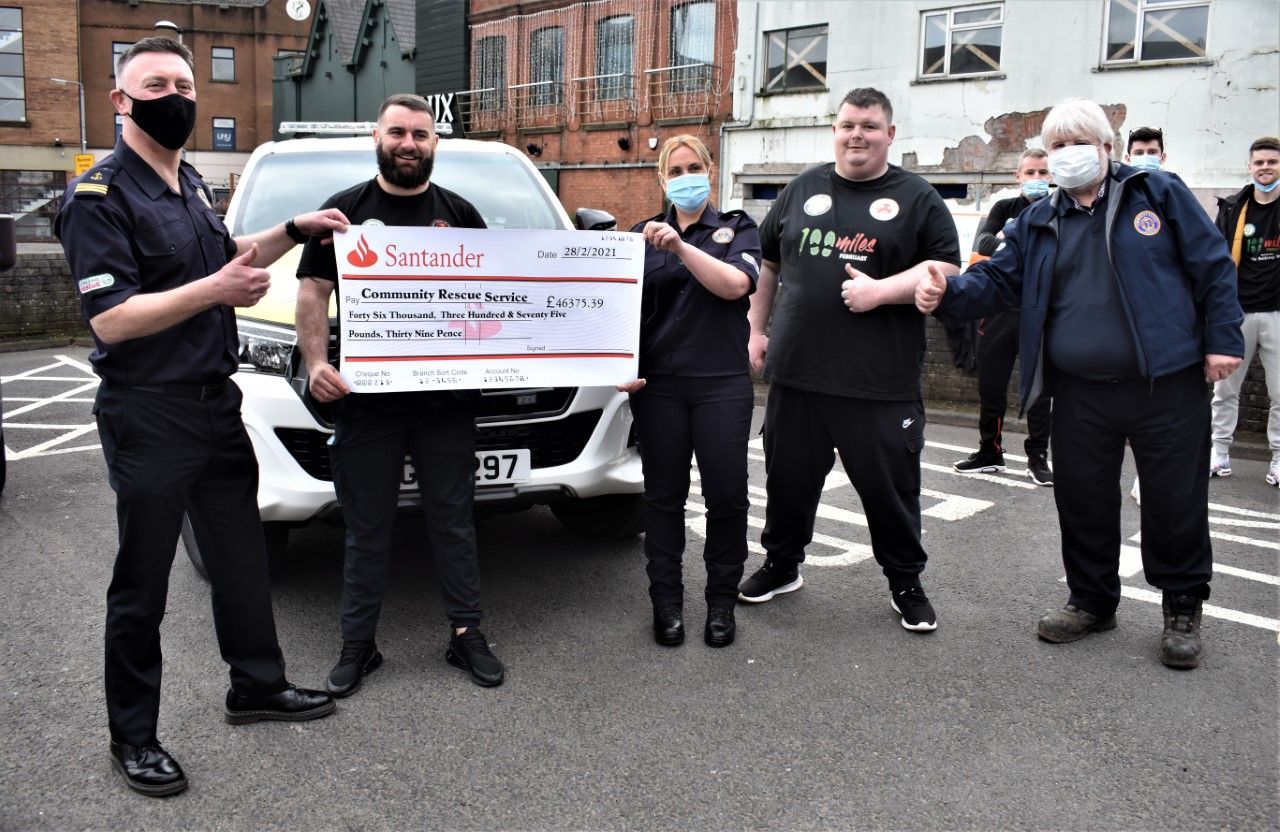 BIG HEARTS: Joe McDonnell and Ryan Whelan handing the cheque over to community search and rescue team