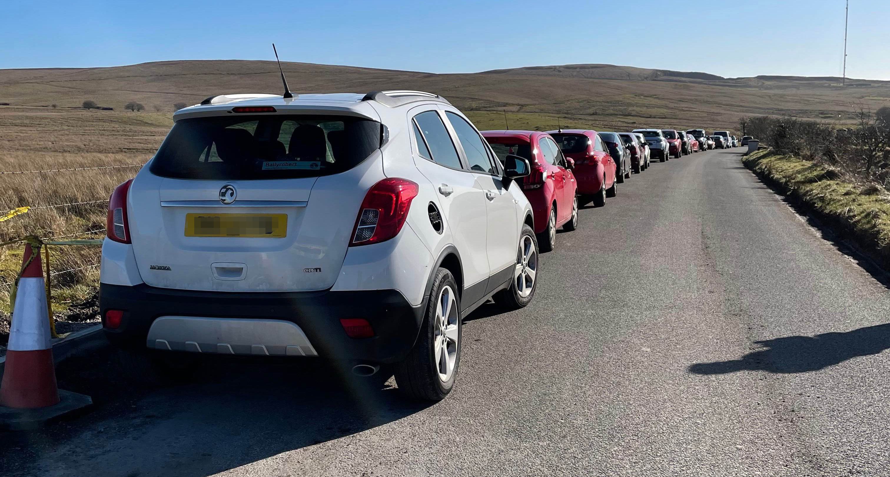 BUMPER TO BUMPER: Cars parked on the side of Divis Road