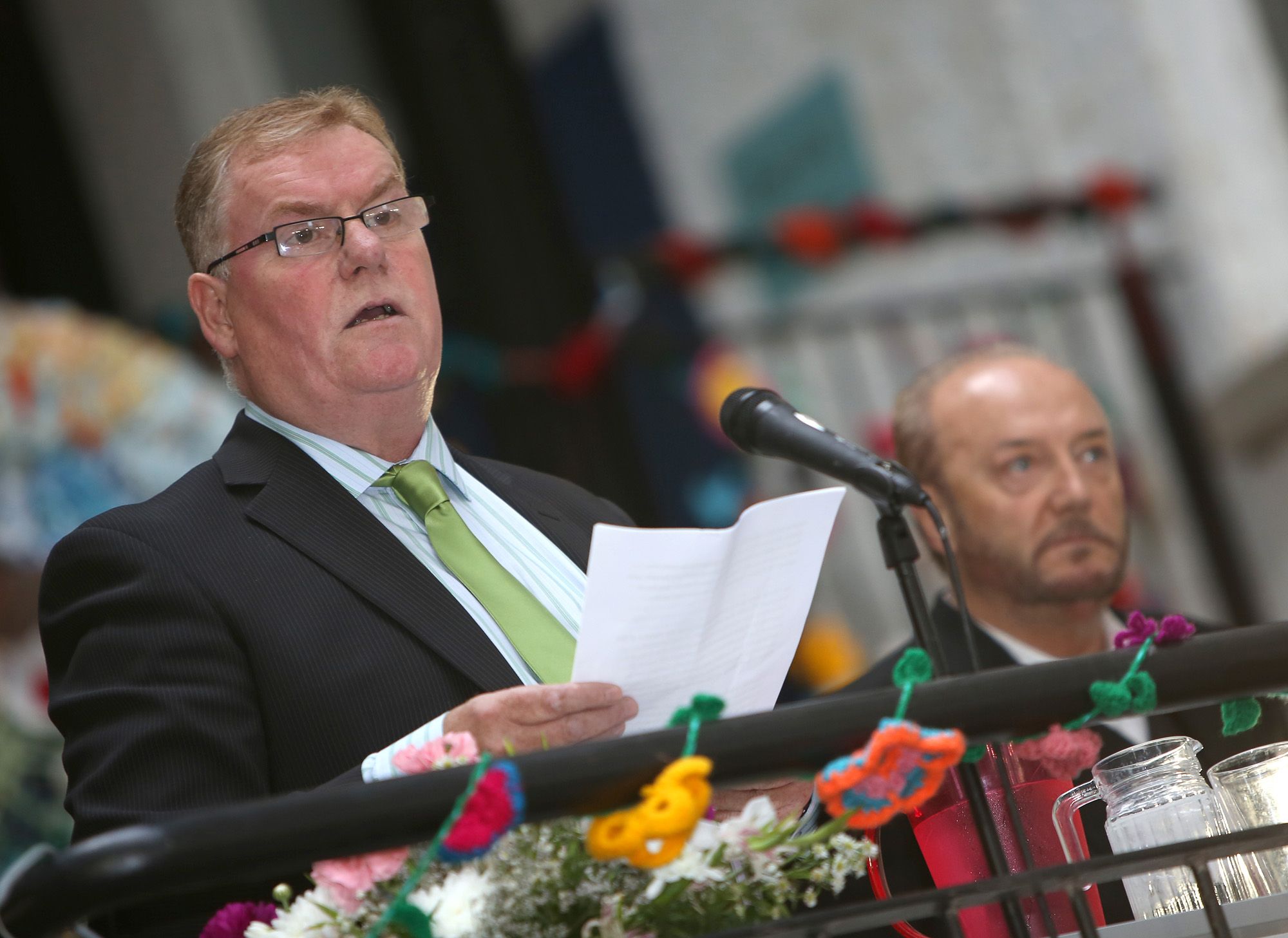 COMMUNITY JUSTICE CAMPAIGNER: Harry Maguire introduces George Galloway at the Frank Cahill lecture during the 2013 Féile an Phobail