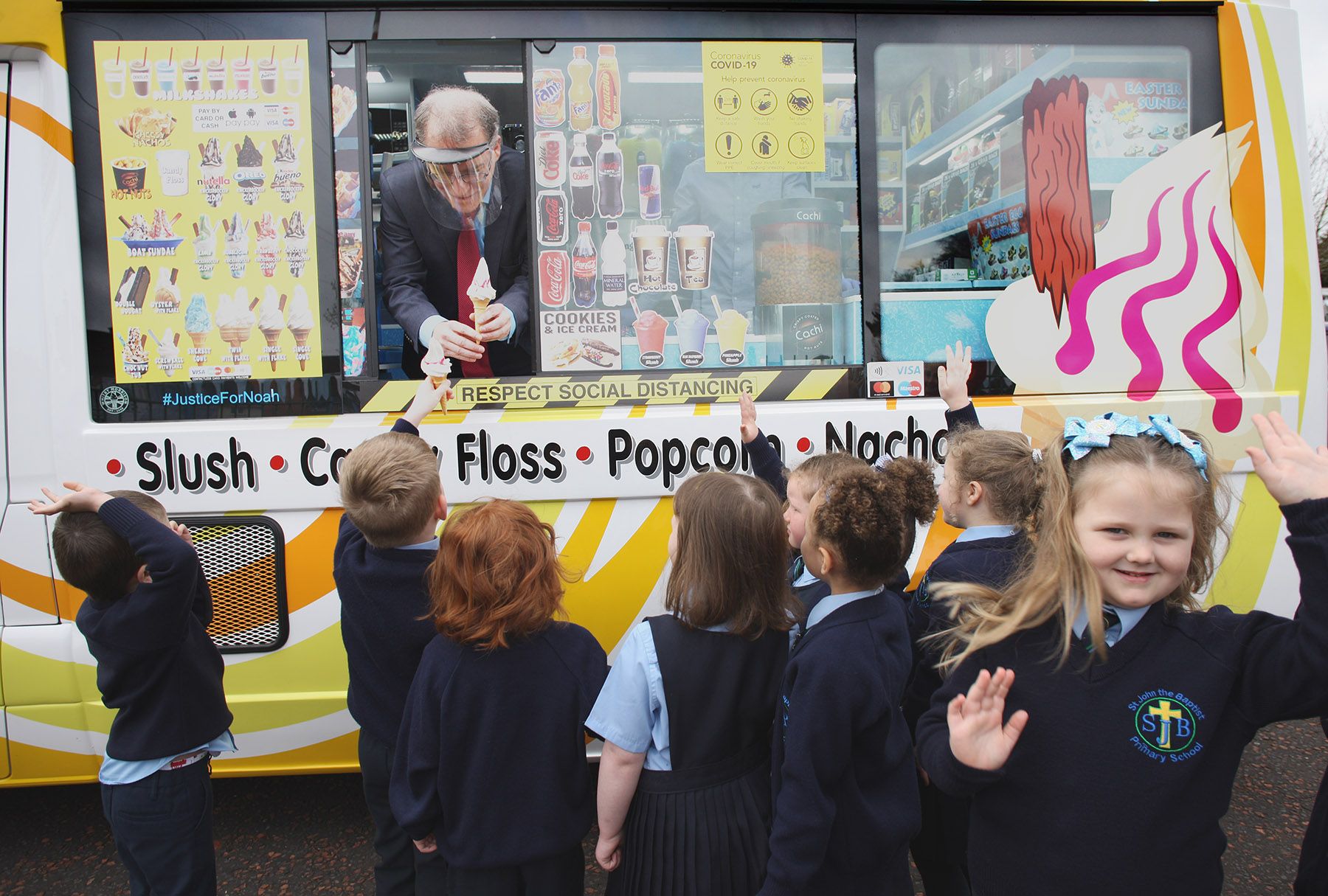 SUNDAE SCHOOL: Principal Chris Donnelly welcomes pupils back to St John the Baptist with an ice cream
