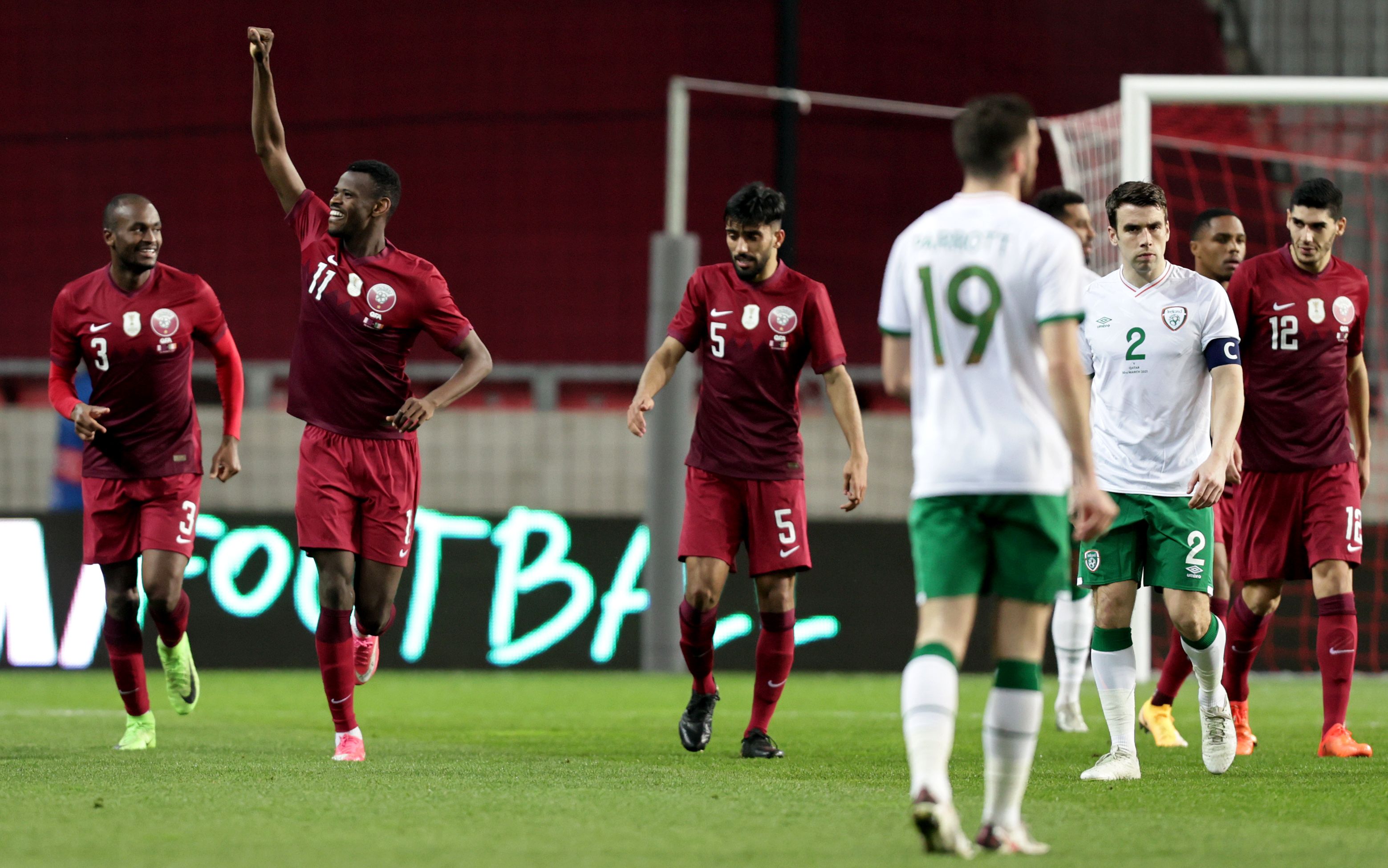 Qatar\'s Mohamed Muntari celebrates scoring the equaliser as Seamus Coleman looks on 