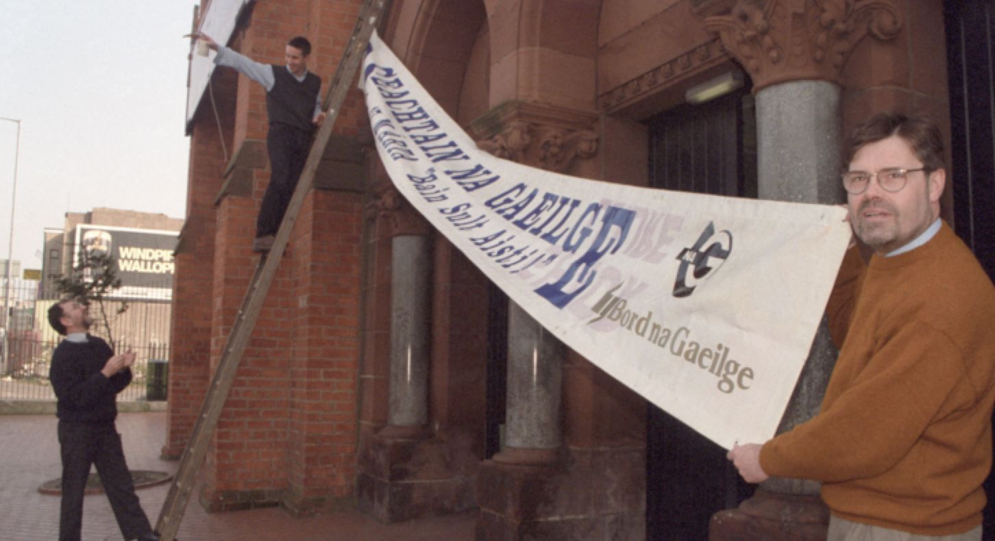 THE WAY WE WERE: Proinsias Ó Labhradhra, then of Meánscoil Feirste, unveils an Irish Language Week banner at An Chultúrlann in 1997