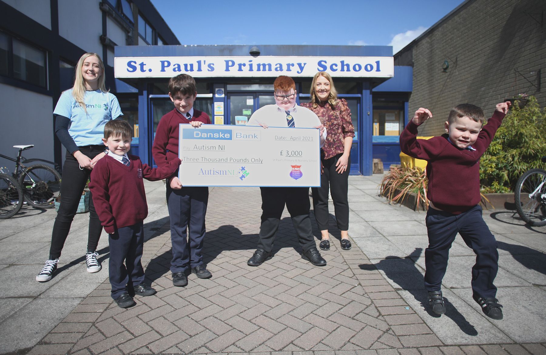 SUPERHEROES: Rachel Gribben from Autism NI accepts a cheque for £3,000 from pupils Ryan, Orrin, Marc Og and Cillian alongside Mrs Róisín McNeill 