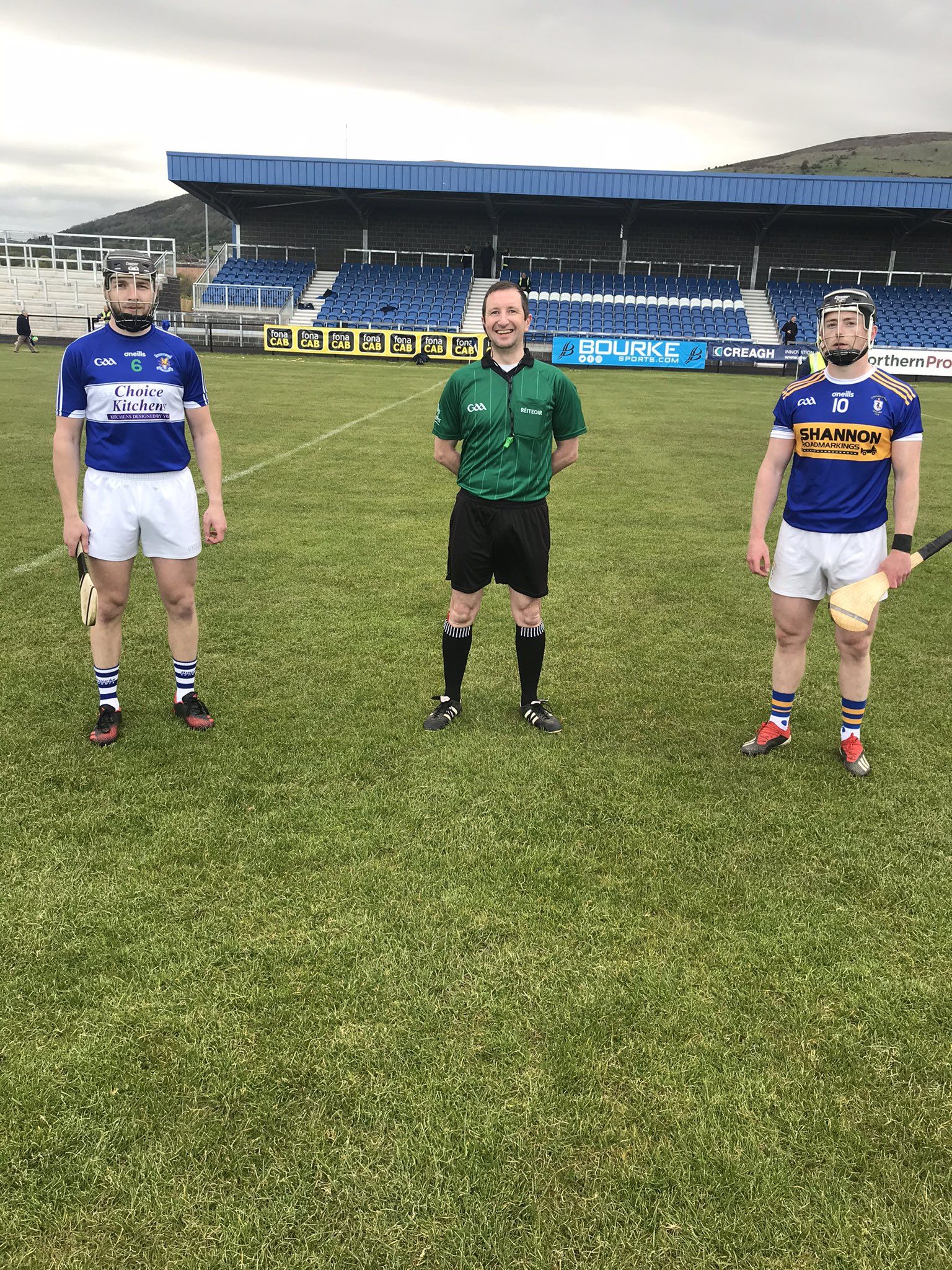 Referee Colum Cunning with team captains, Conal Moragn (St John\'s) and Thomas Morgan (Rossa)