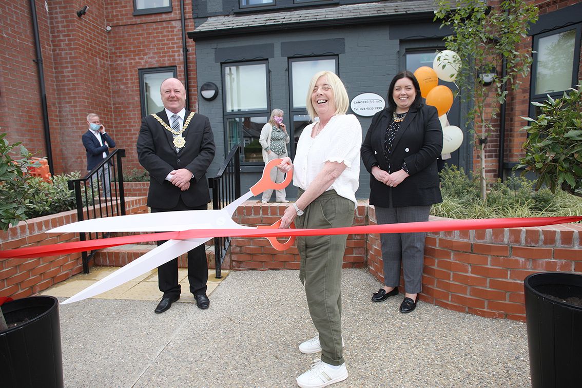 OPEN: Bernie Montgomery, Chairperson of Cancer Lifeline, does the honours with the reopening, with Belfast Mayor Frank McCoubrey and Minister for Communities Deirdre Hargey 