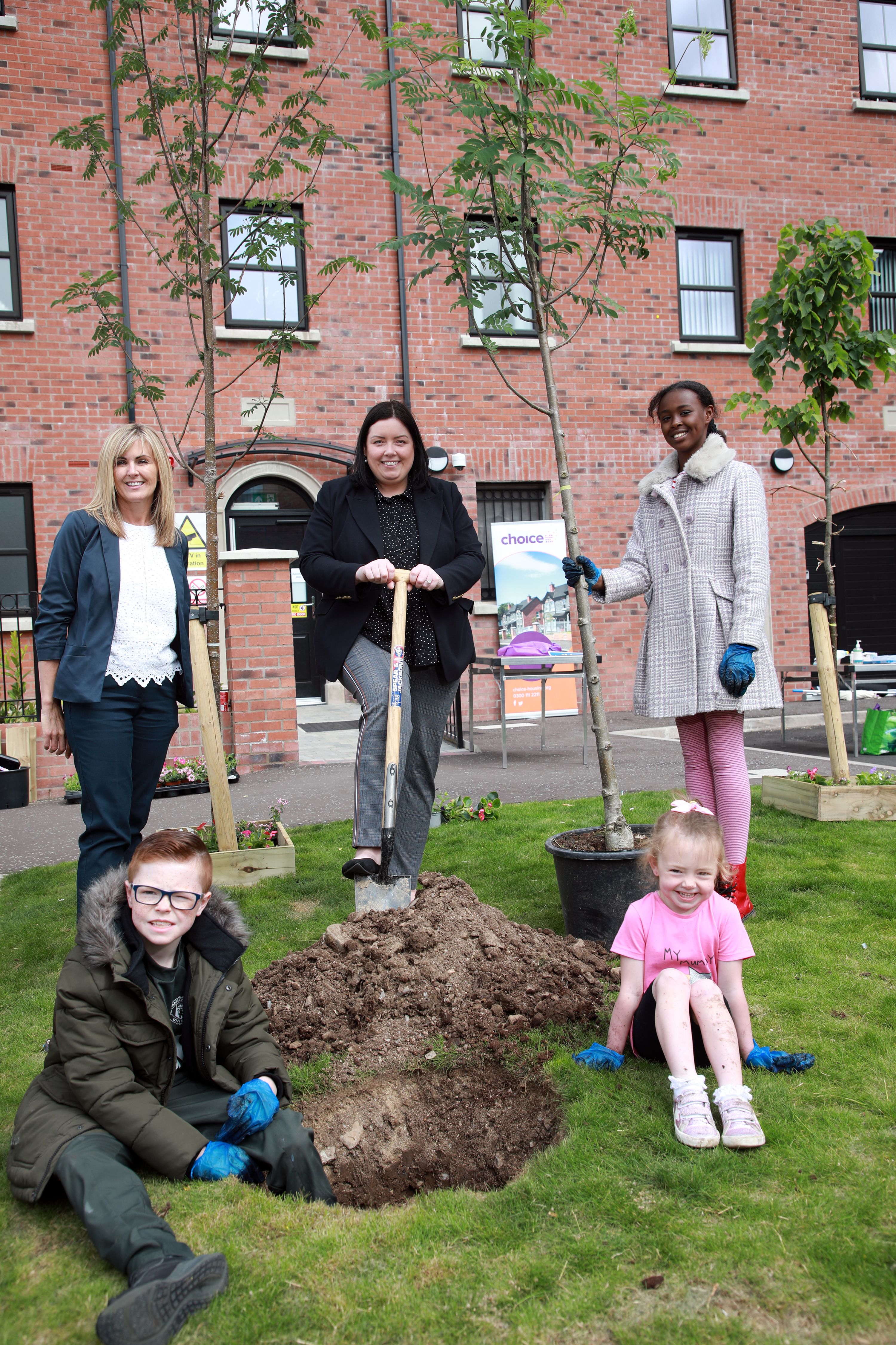 GREEN FINGERS: Carole Irvine from Choice Housing, Minister for Communities Deirdre Hargey, with local children Hayaam Mahamuud, Meabh and Aodhan Conlon.