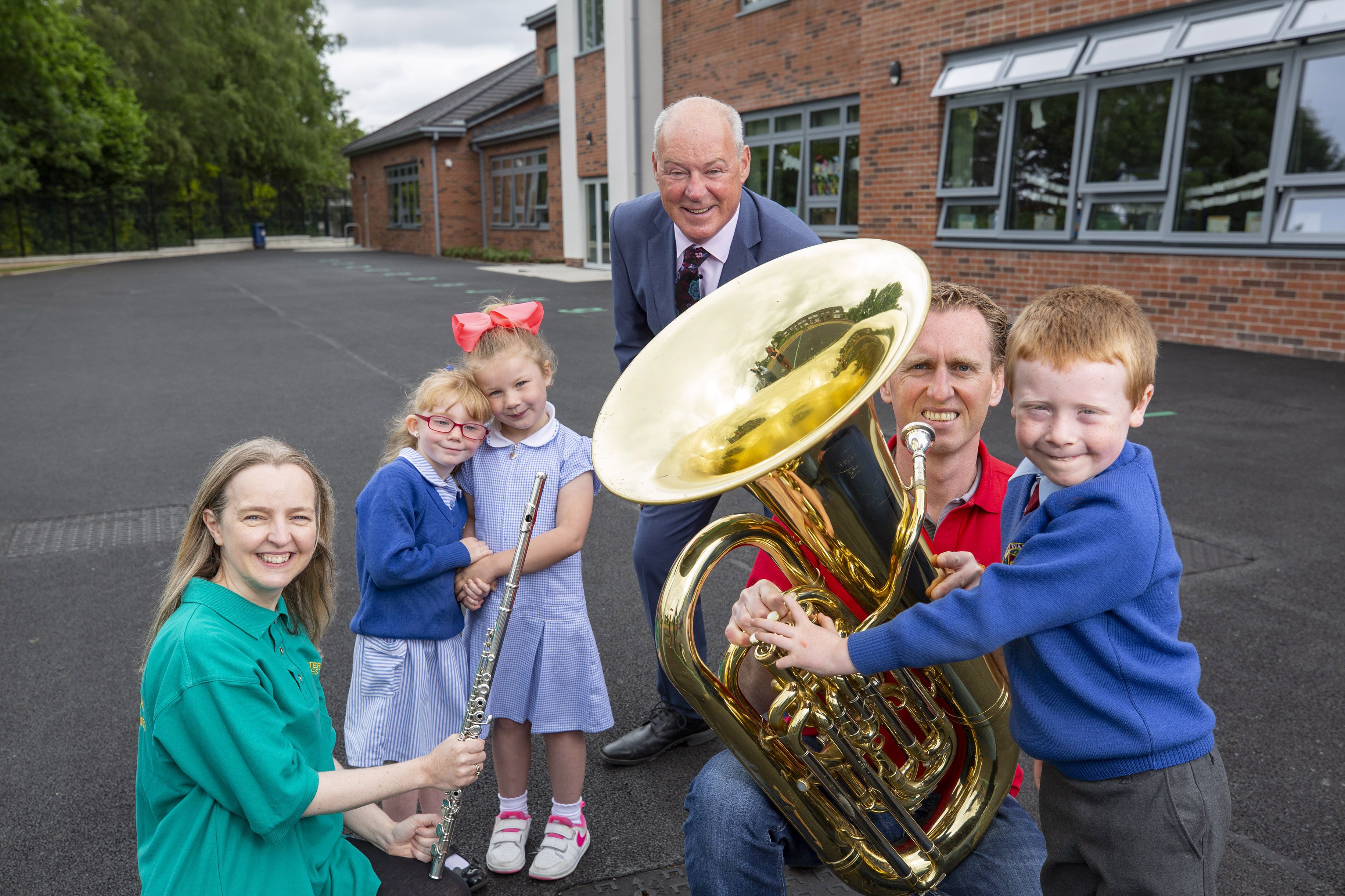 LOVE OF MUSIC: At the Ulster Orchestra’s Crescendo workshop at Holy Evangelists’ Primary School in Twinbrook are (L-R), Ulster Orchestra player, Jennifer Sturgeon, students, Cara Fitzsimmons and Ruby Christie Whelan, Liam Hannaway, Chair, Arts Council NI