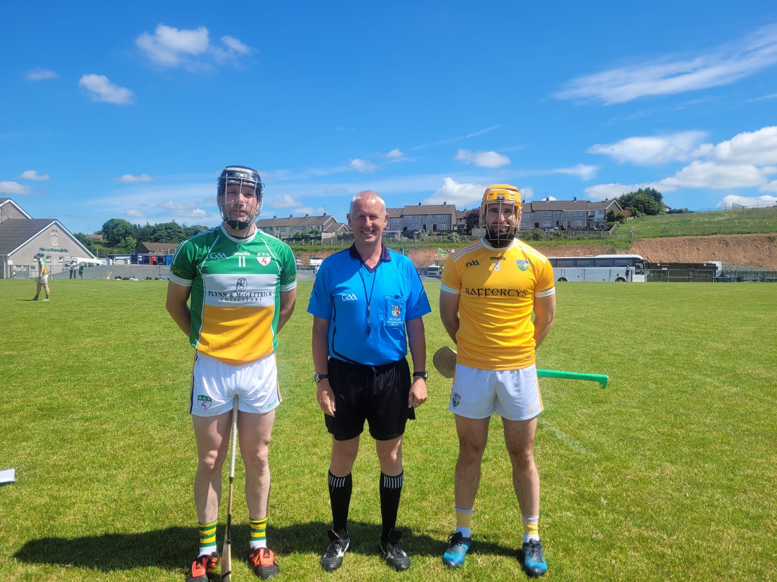 Referee Brendan Toland with Davitt\'s captain Stephen McGivern and Cuchulainn\'s captain Conor Devlin 