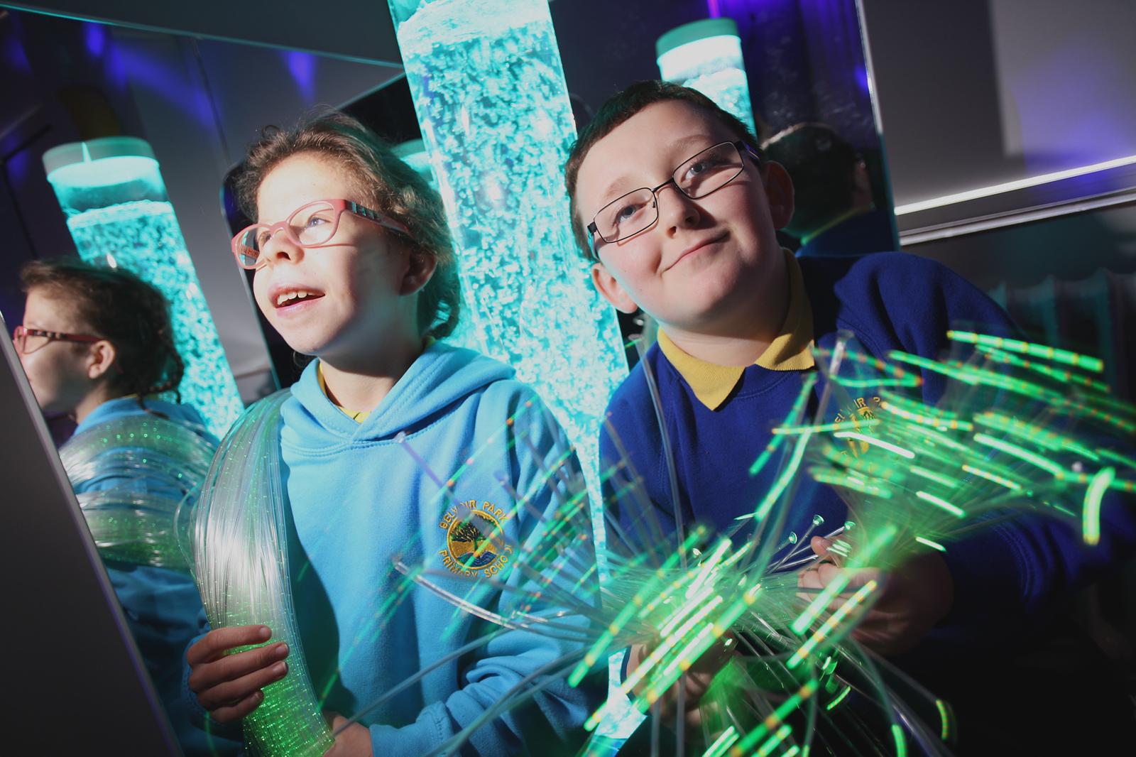 AWESOME: Jake Collins and Paige Marshall in the new sensory room at Belvoir Park Primary School