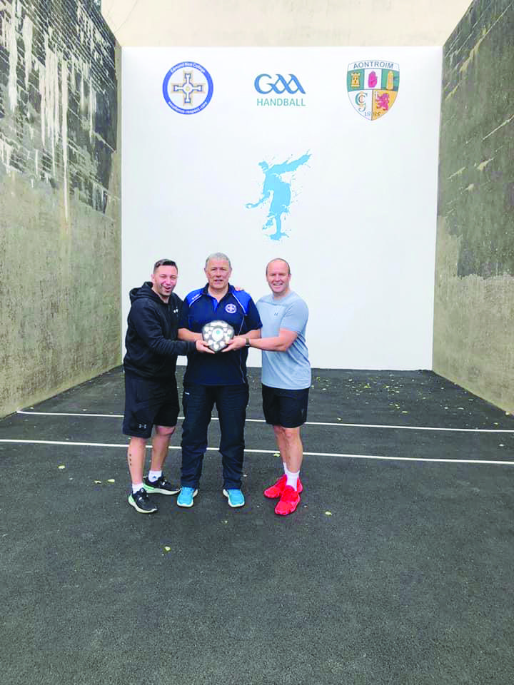 Handballers Ricky McCann and Paul Graham with Sean Fleming, who recently retired as a teacher at Edmund Rice